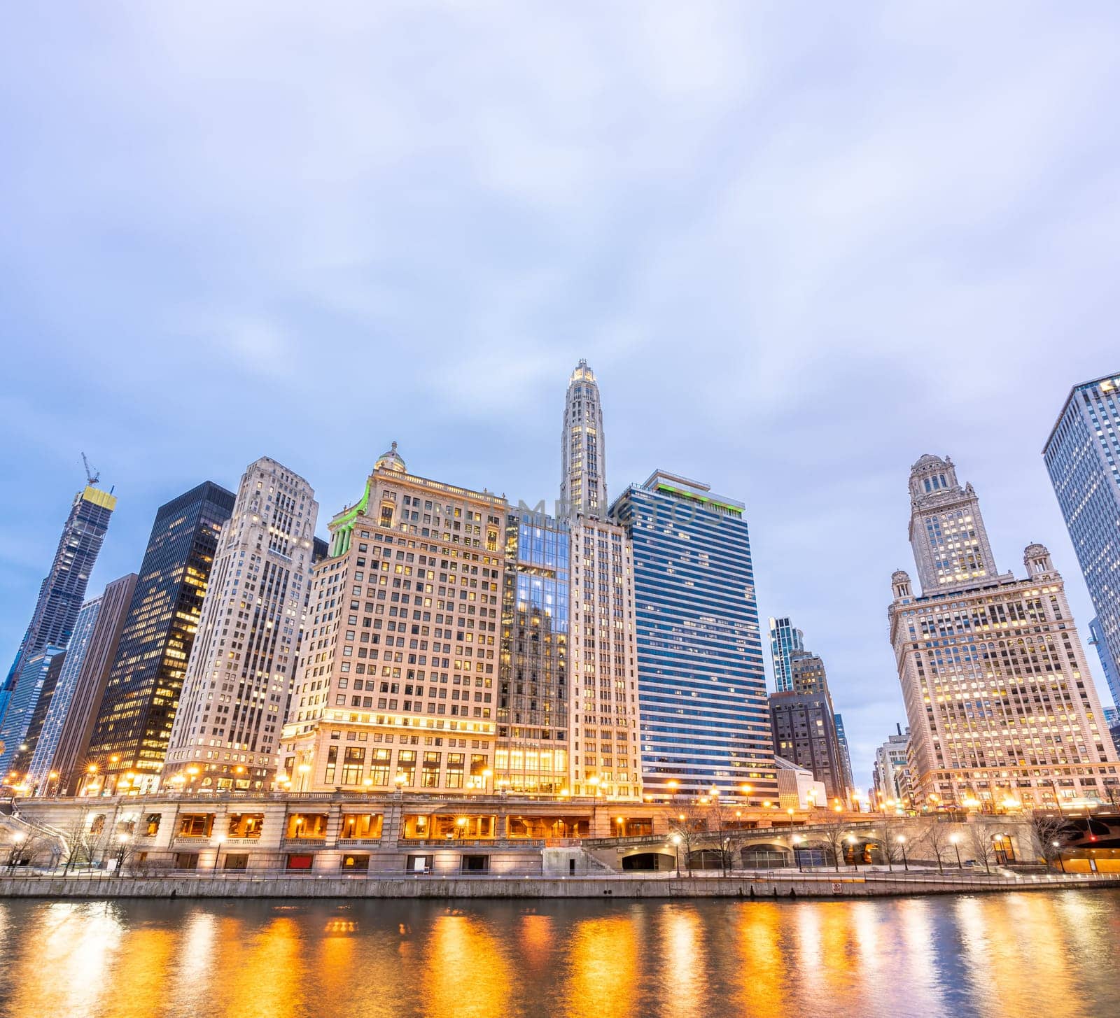 City of Chicago downtown and Chicago River sunset night in Chicago Illinois USA.