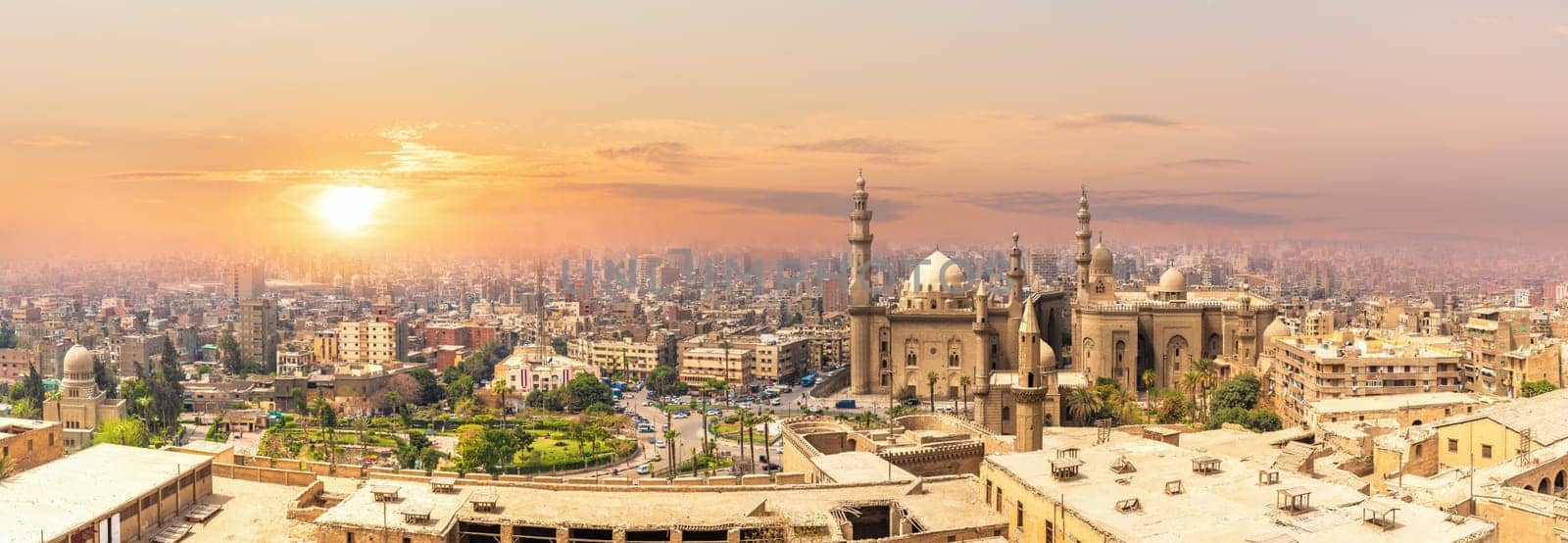 Mosque-Madrassa of Sultan Hassan in the sunset panorama of Cairo, Egypt.