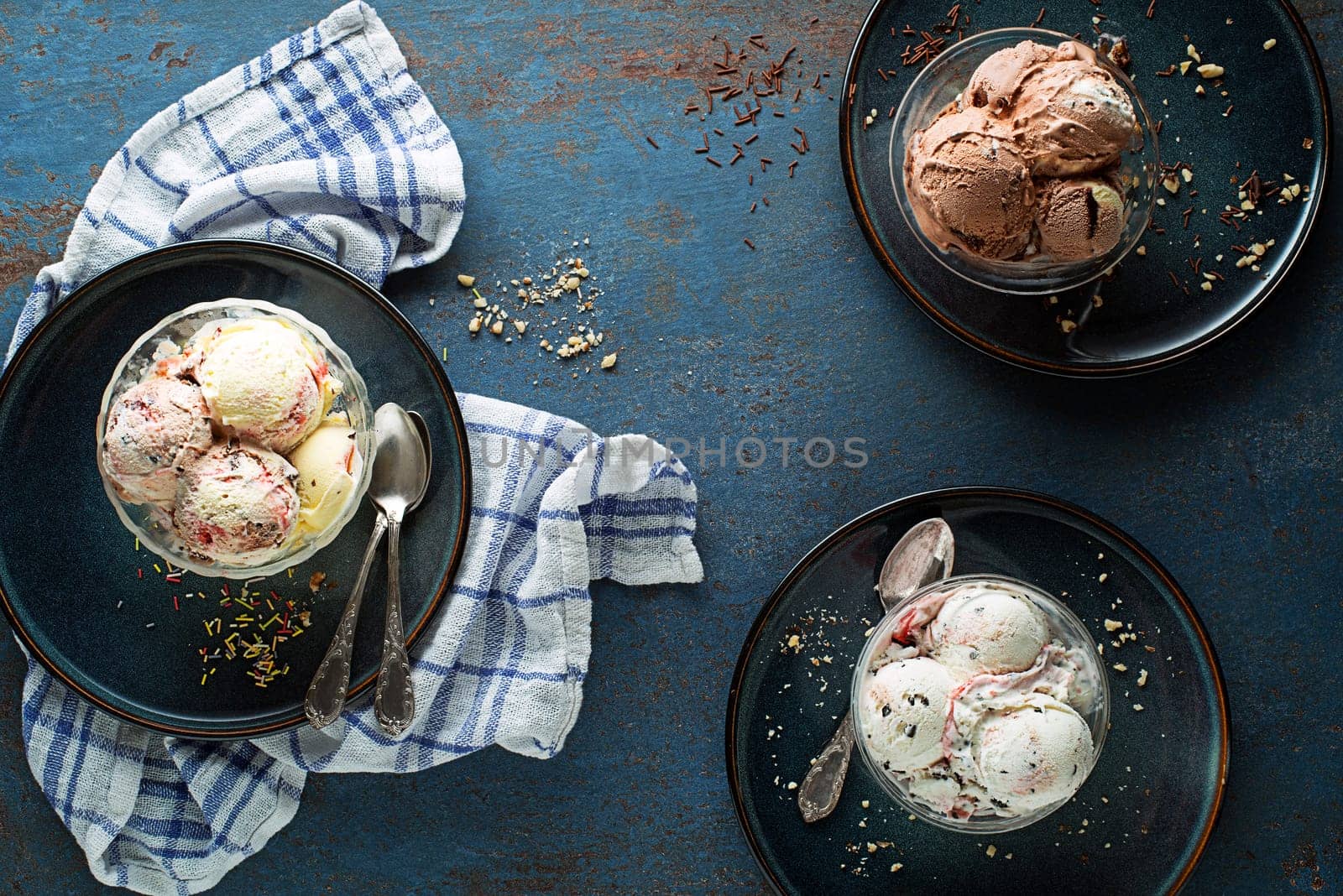 Set of ice cream scoops of different colors and flavours with berries, nuts and fruits