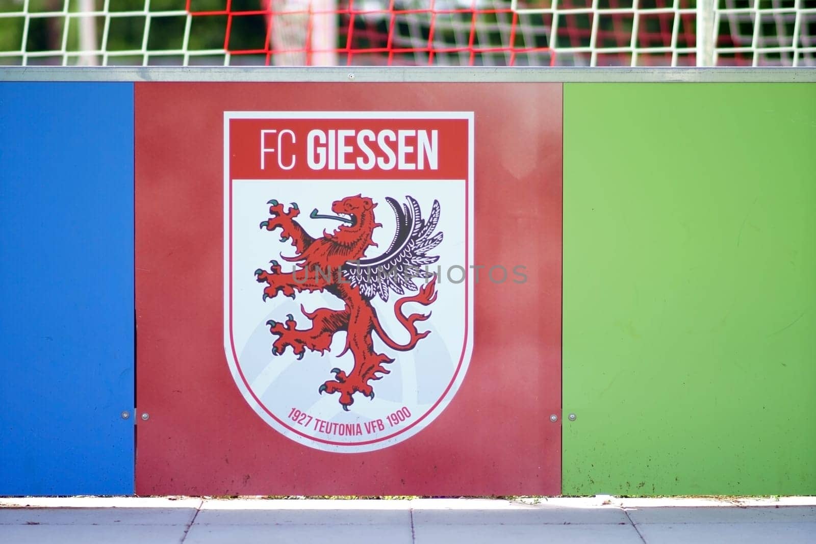 Giessen, Germany - August 13, 2019: The coat of arms of the football club FC Giessen at the band of the Waldstadion at a game of the regional league on 13 August 2019 in Giessen..