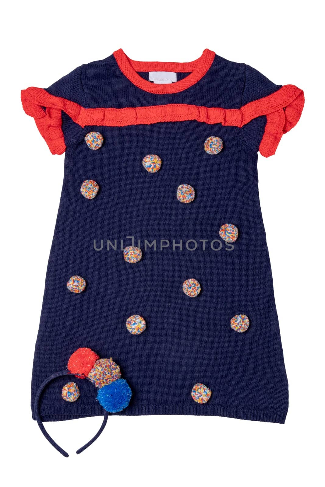 Clothes for children. A beautiful blue sleeveless dress with red collar, ruffles and with fluffy fabric balls and a hairband isolated on a white background. Little girl autumn and spring fashion.