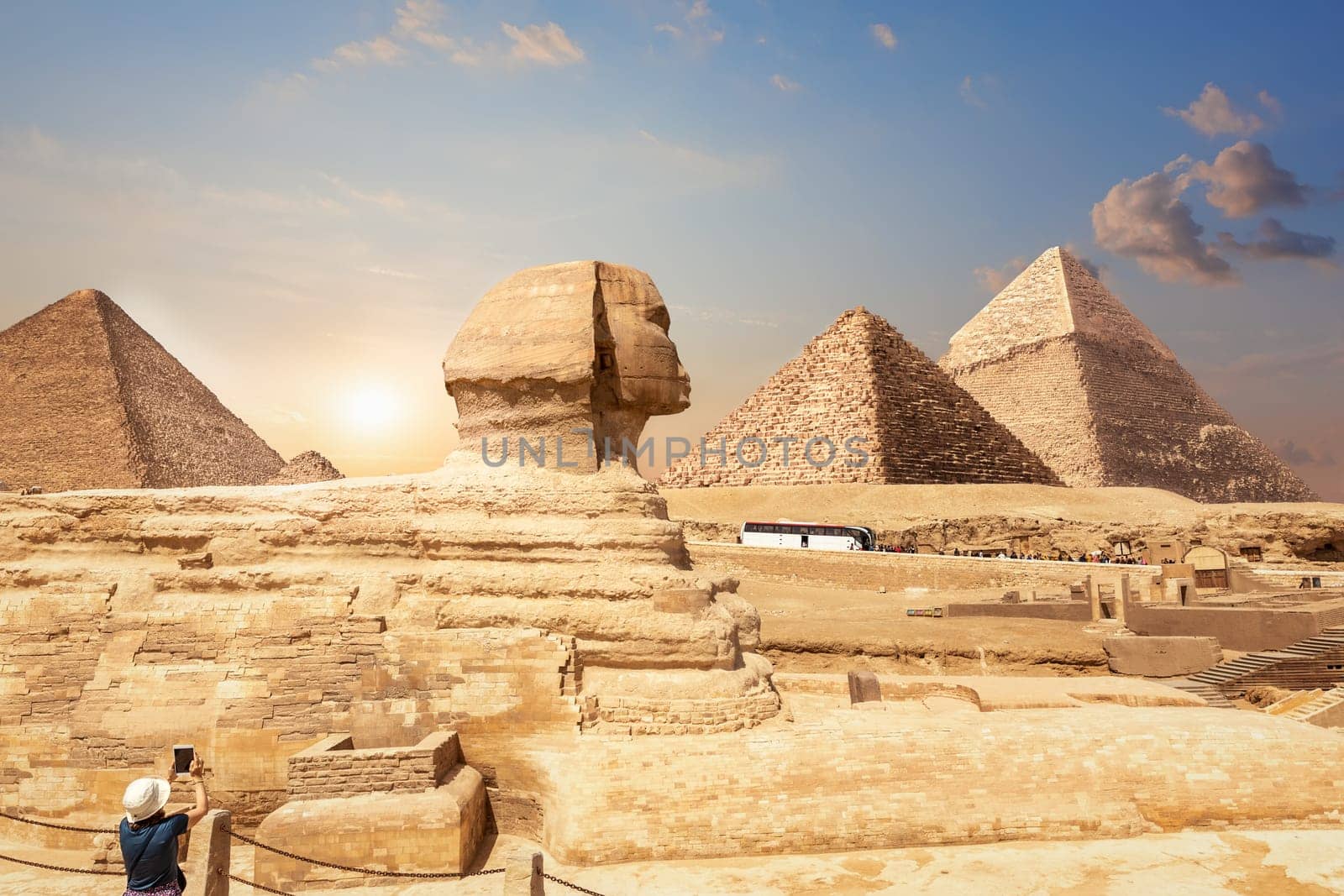 A tourist in Giza enjoying the Sphinx and the Pyramids, Egypt.