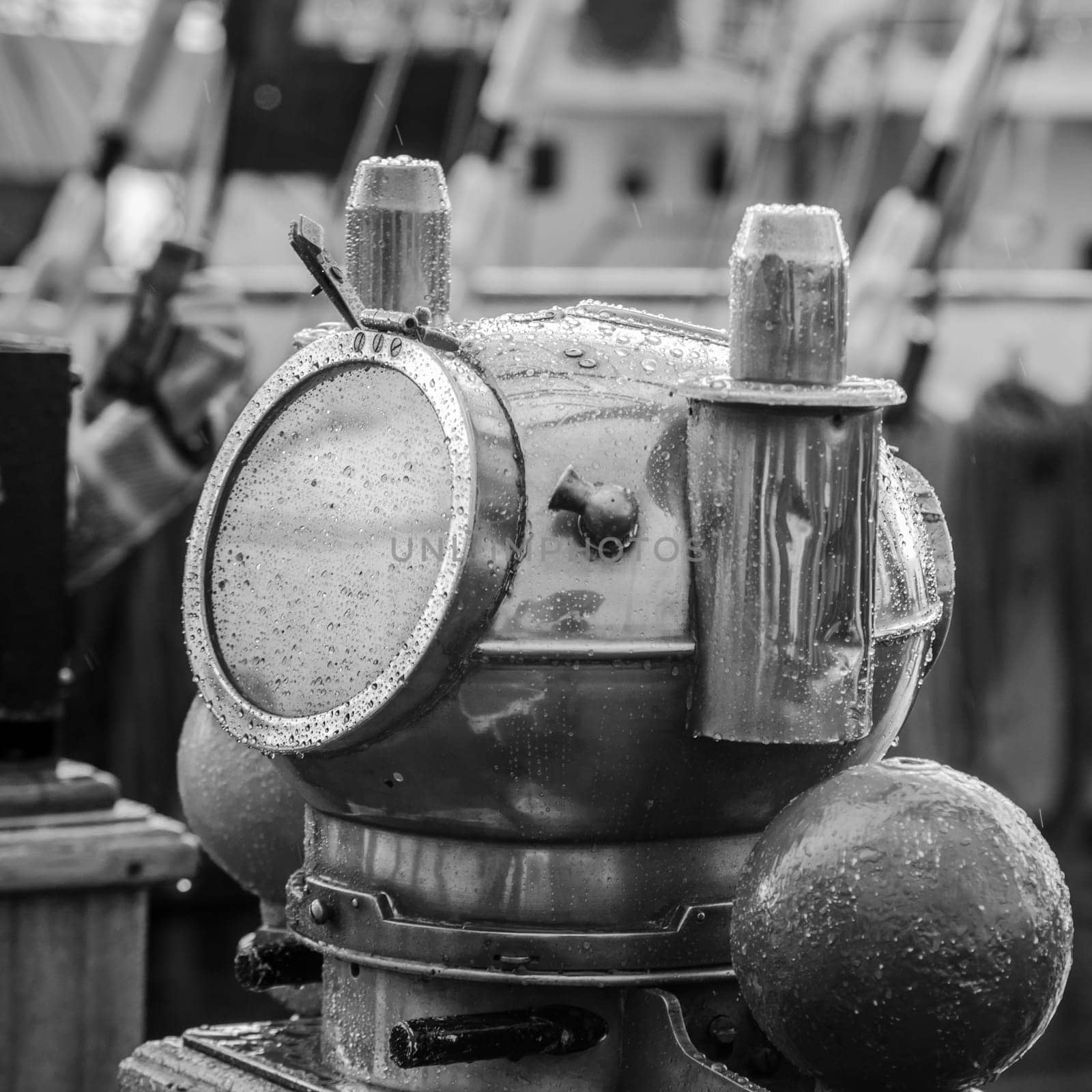 Reflection of a mast in an old ship compass, closeup. Black and white photo
