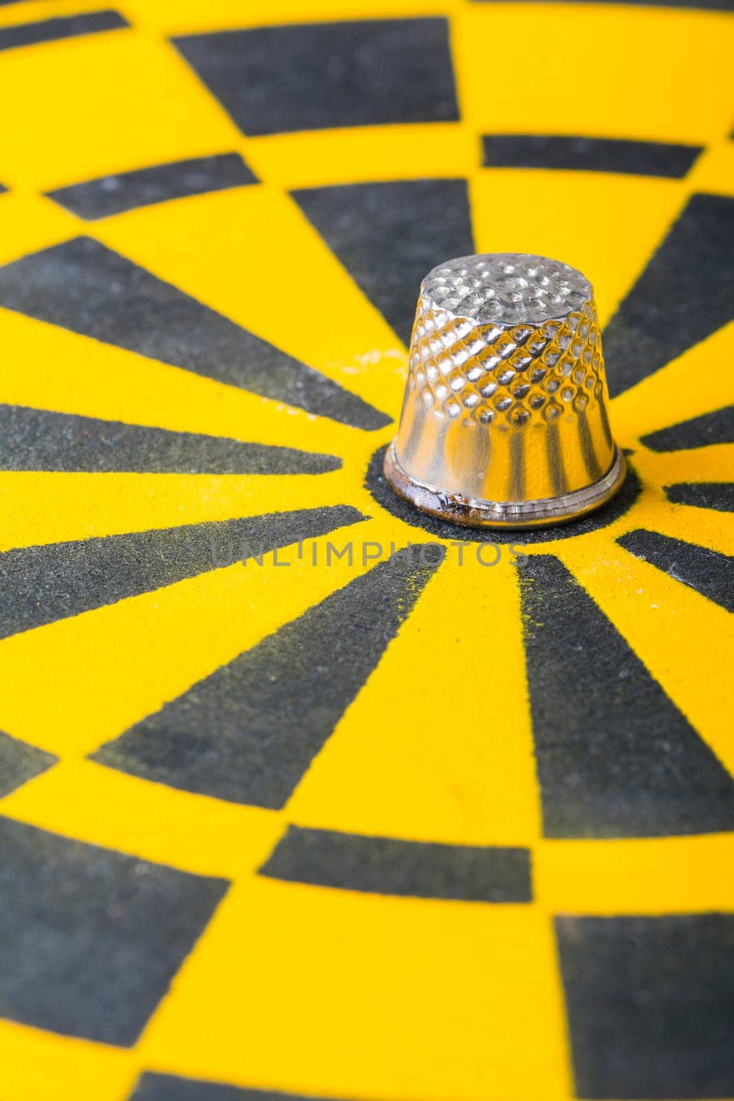 a thimble on an dartboard - symbol foto - closeup