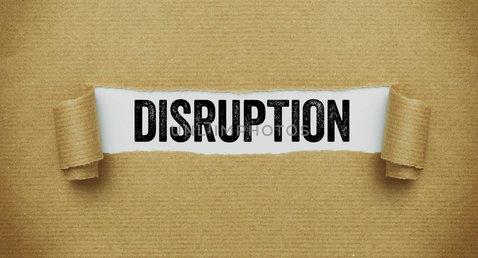 Torn brown paper revealing the word Disruption