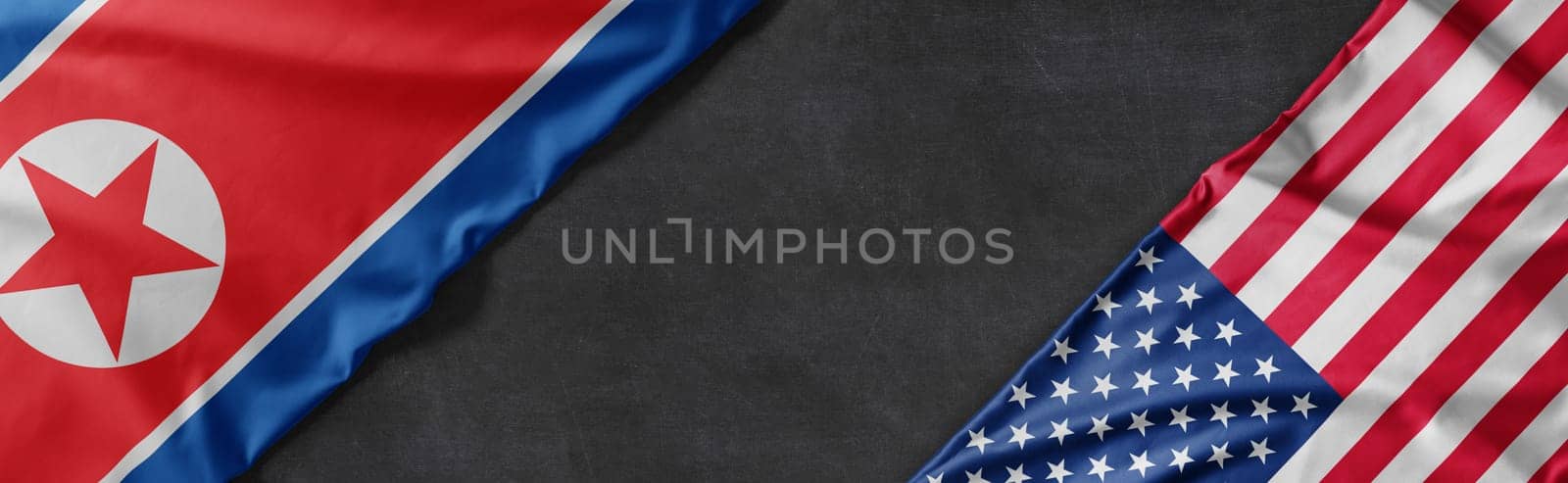 Flags of North Korea and the United States of America with copy space