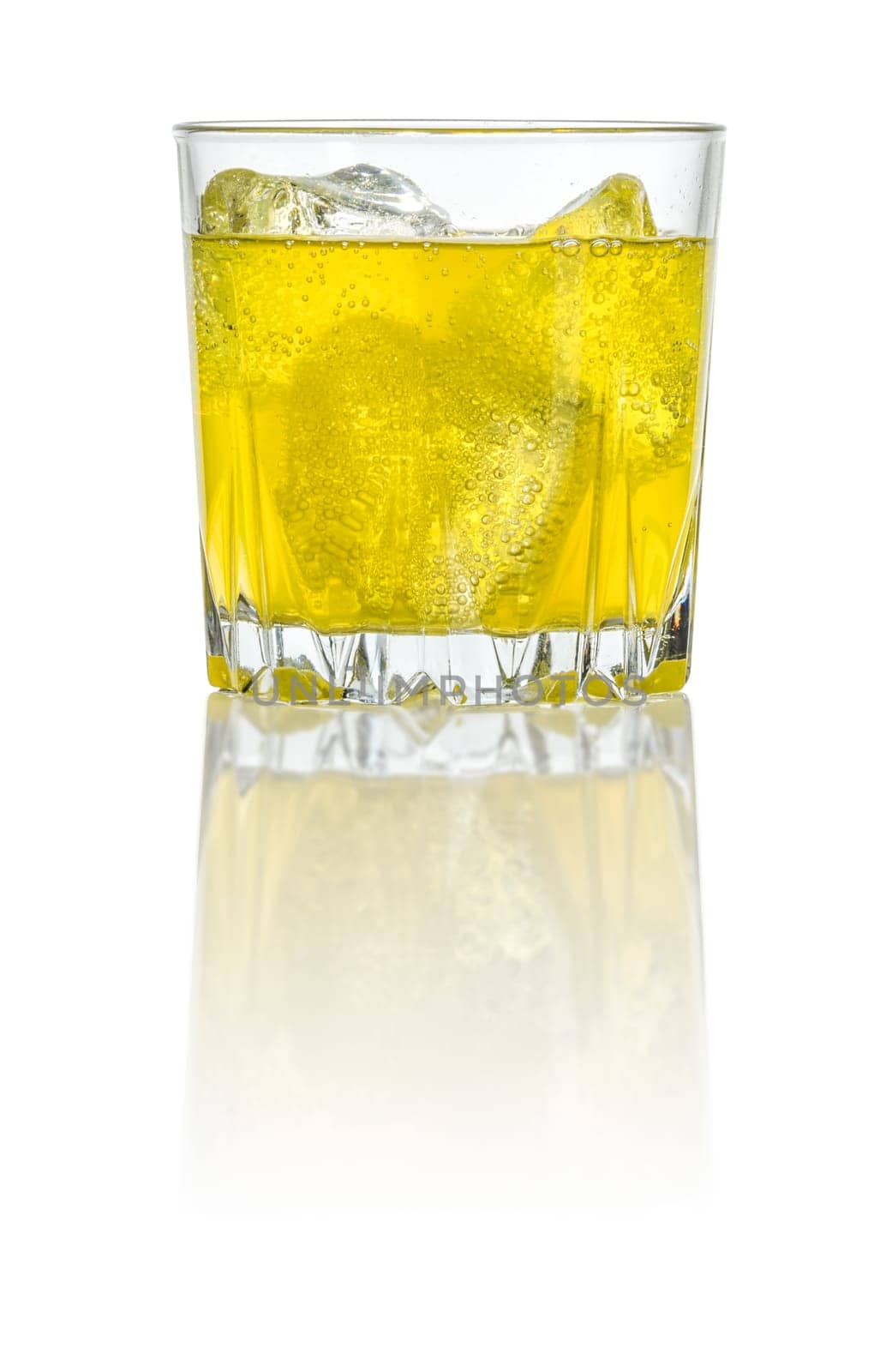 An orange soft drink with ice cubes