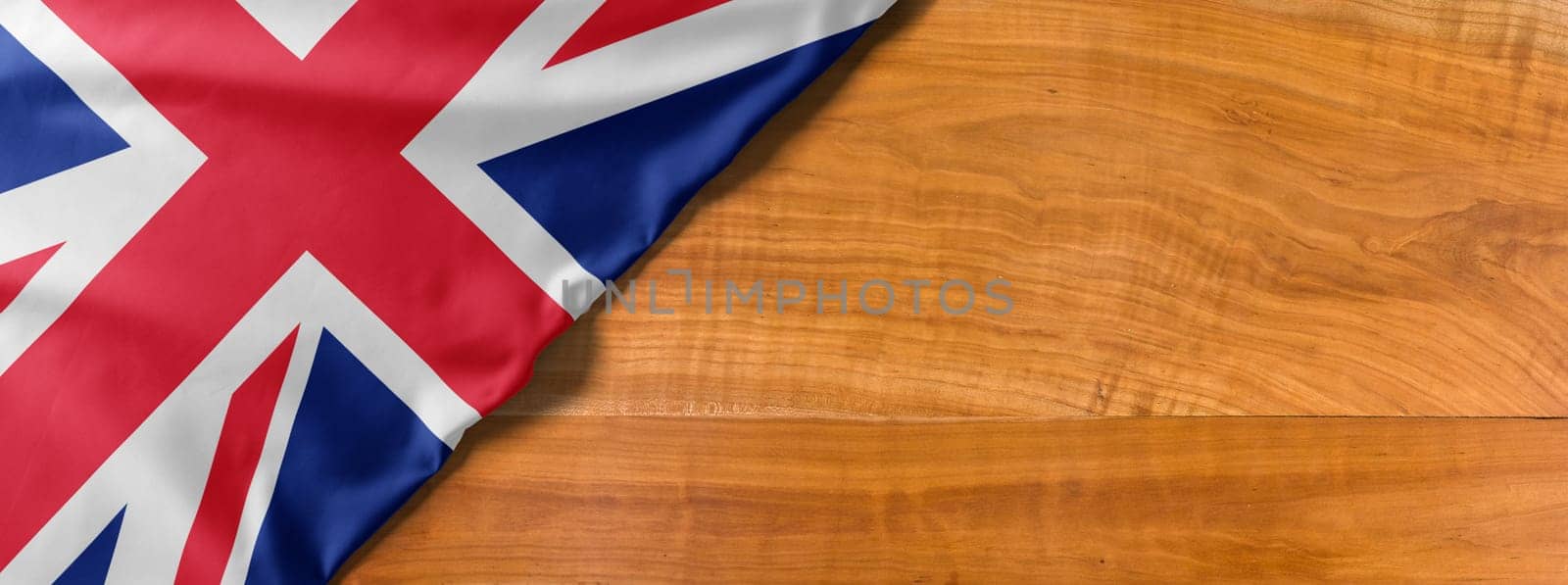 National flag of Great Britain on a wooden background with copy space