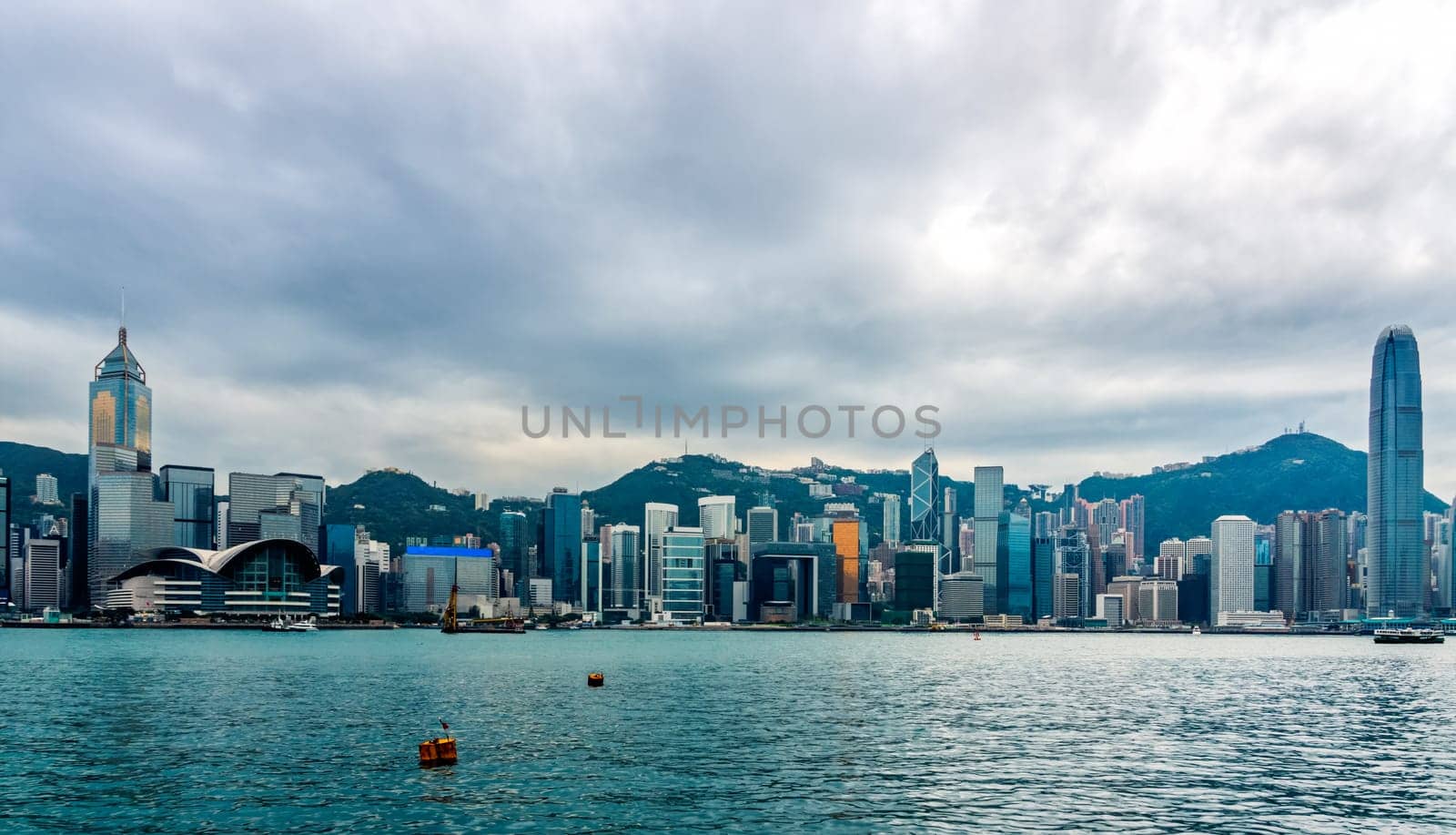 Stormy clouds over Hong Kong bay and island, wide panorama with city scyline, Victoria Peak, China