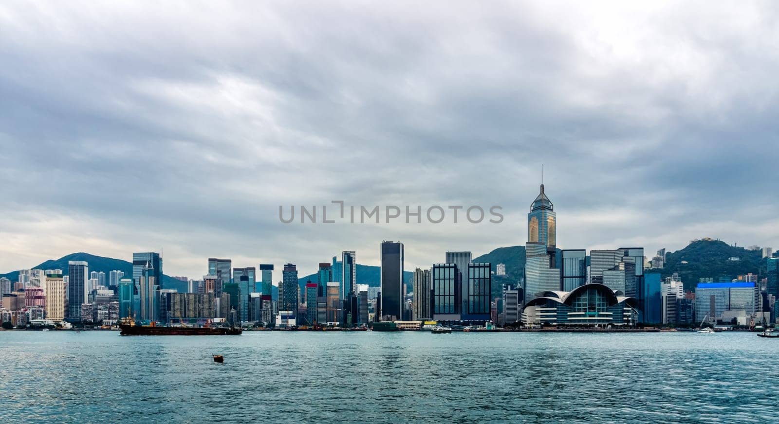 Stormy clouds over Hong Kong bay and island, wide panorama with city scyline, Victoria Peak, China