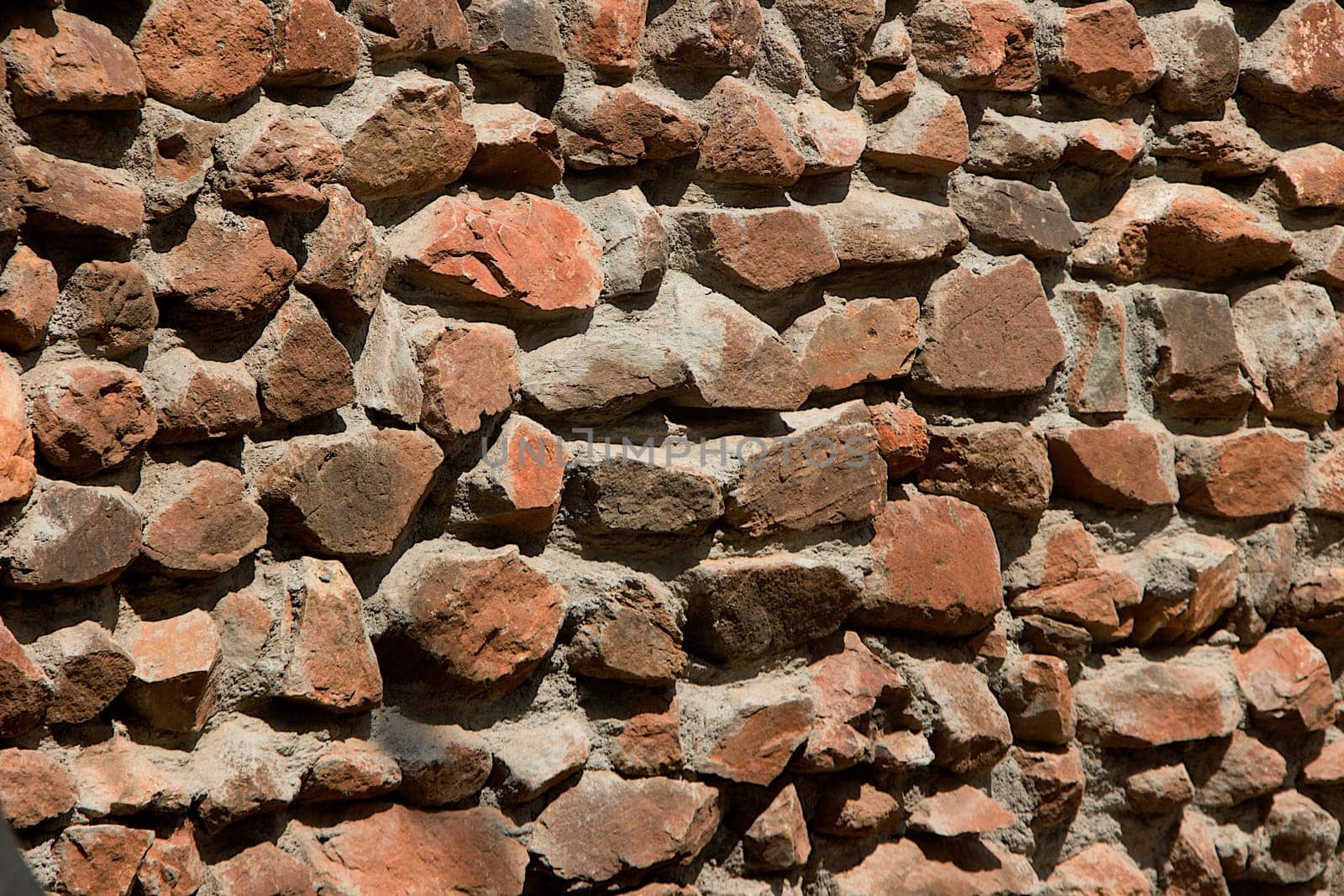 Construction of rubble stone masonry wall with dressed face bonded with cement concrete