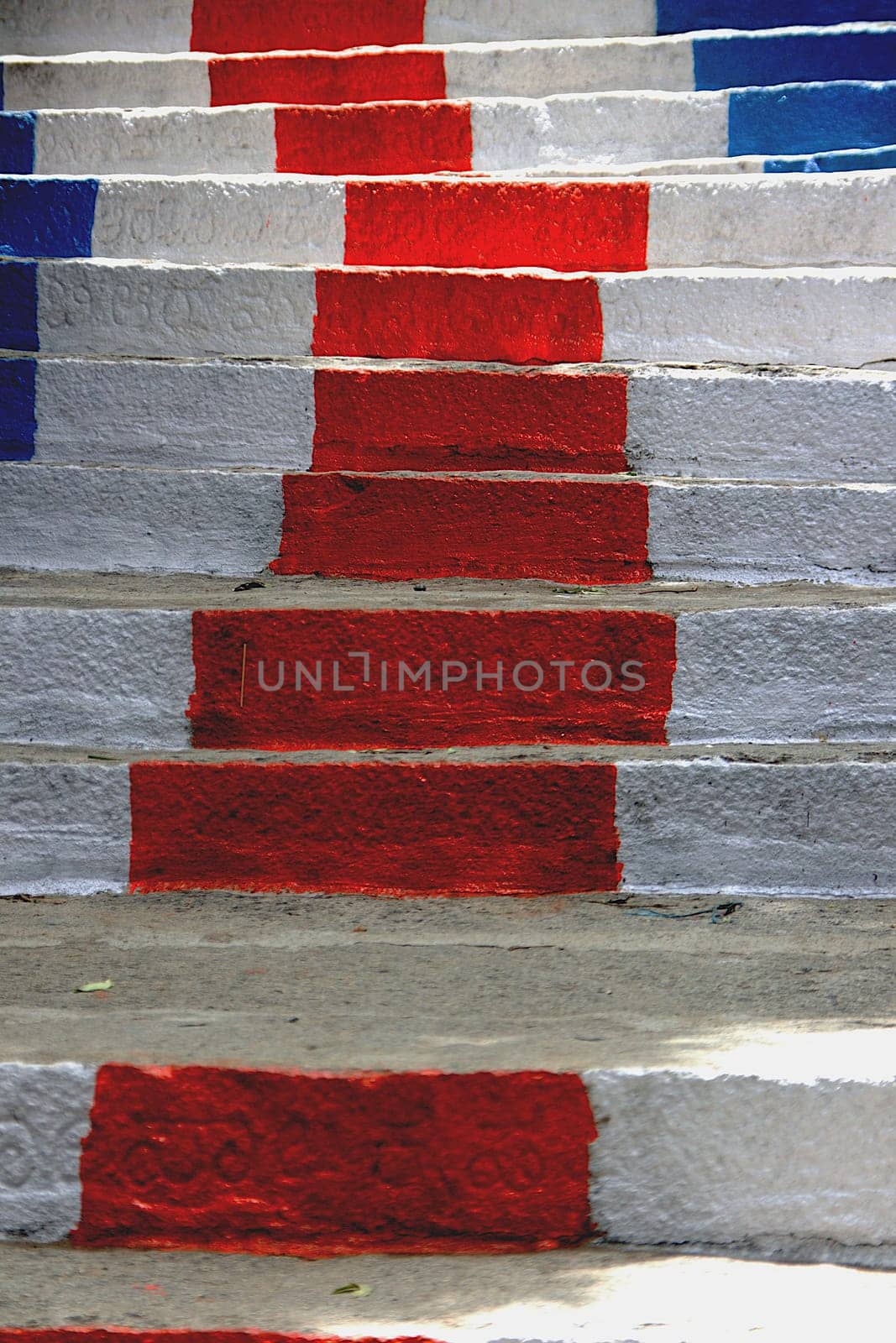 White, blue and red color painted stone steps leading to Ramagiri Hill near Ramanagara, Karnataka, India, Asia