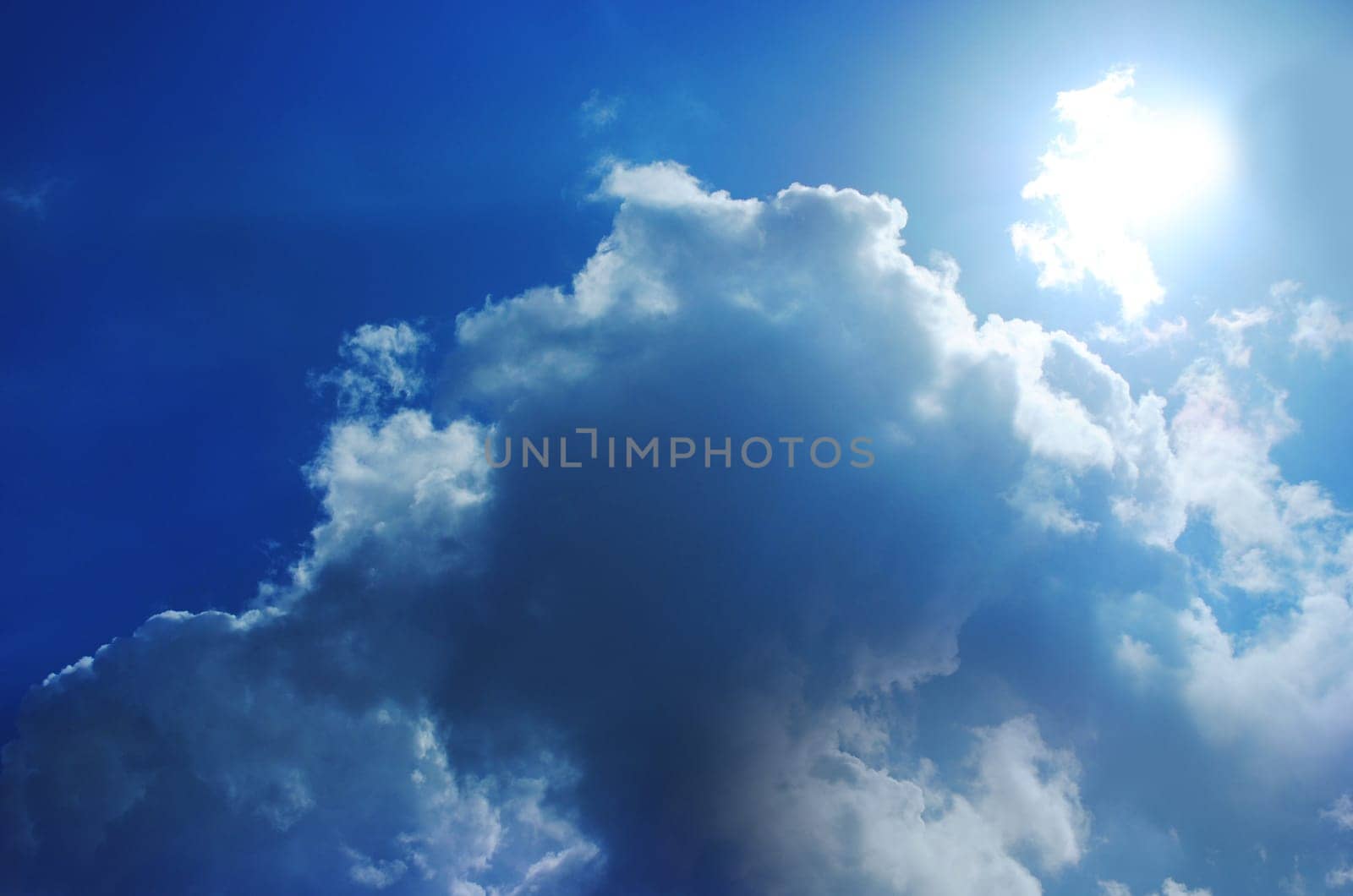 Small bright cloud at the dark cloudy sky