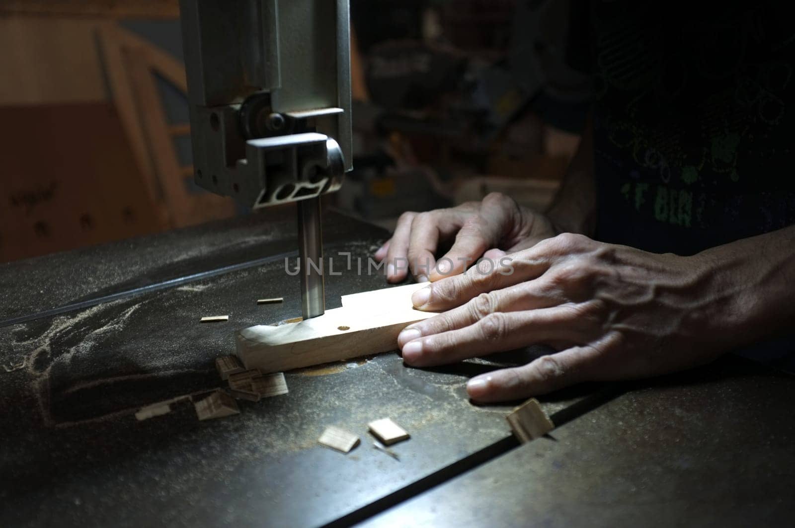 Carpenter builder working with electric jigsaw and wood. Woodworker cutting a piece of wood