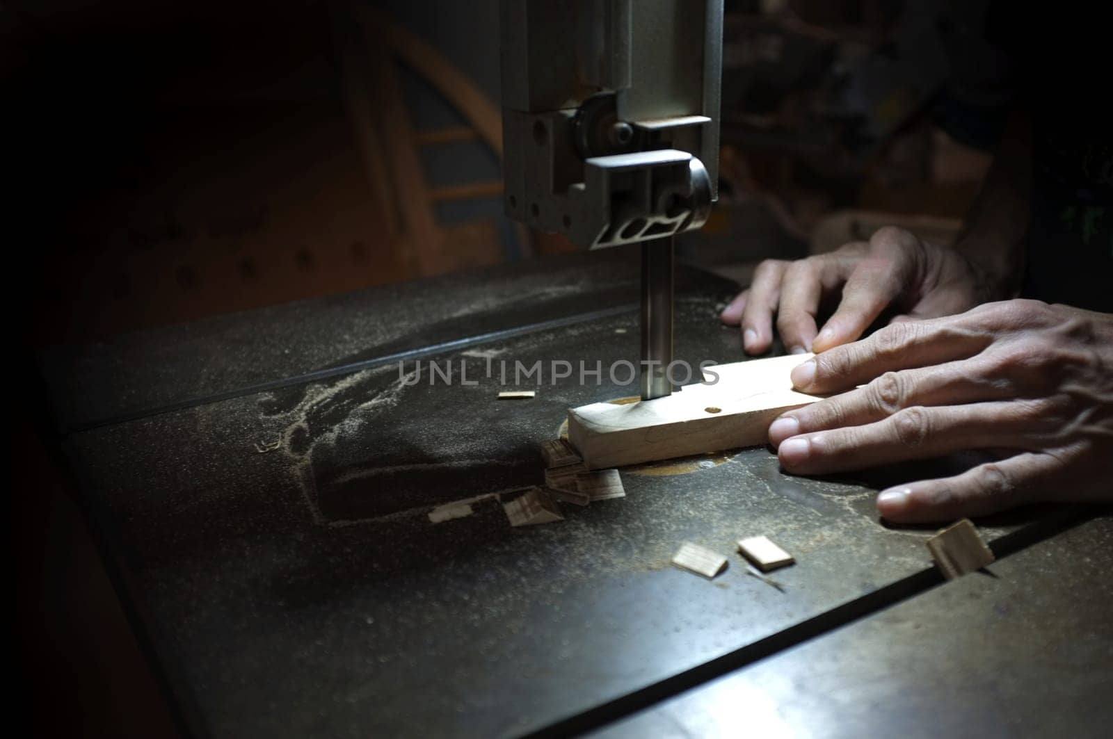 Carpenter builder working with electric jigsaw and wood. Woodworker cutting a piece of wood
