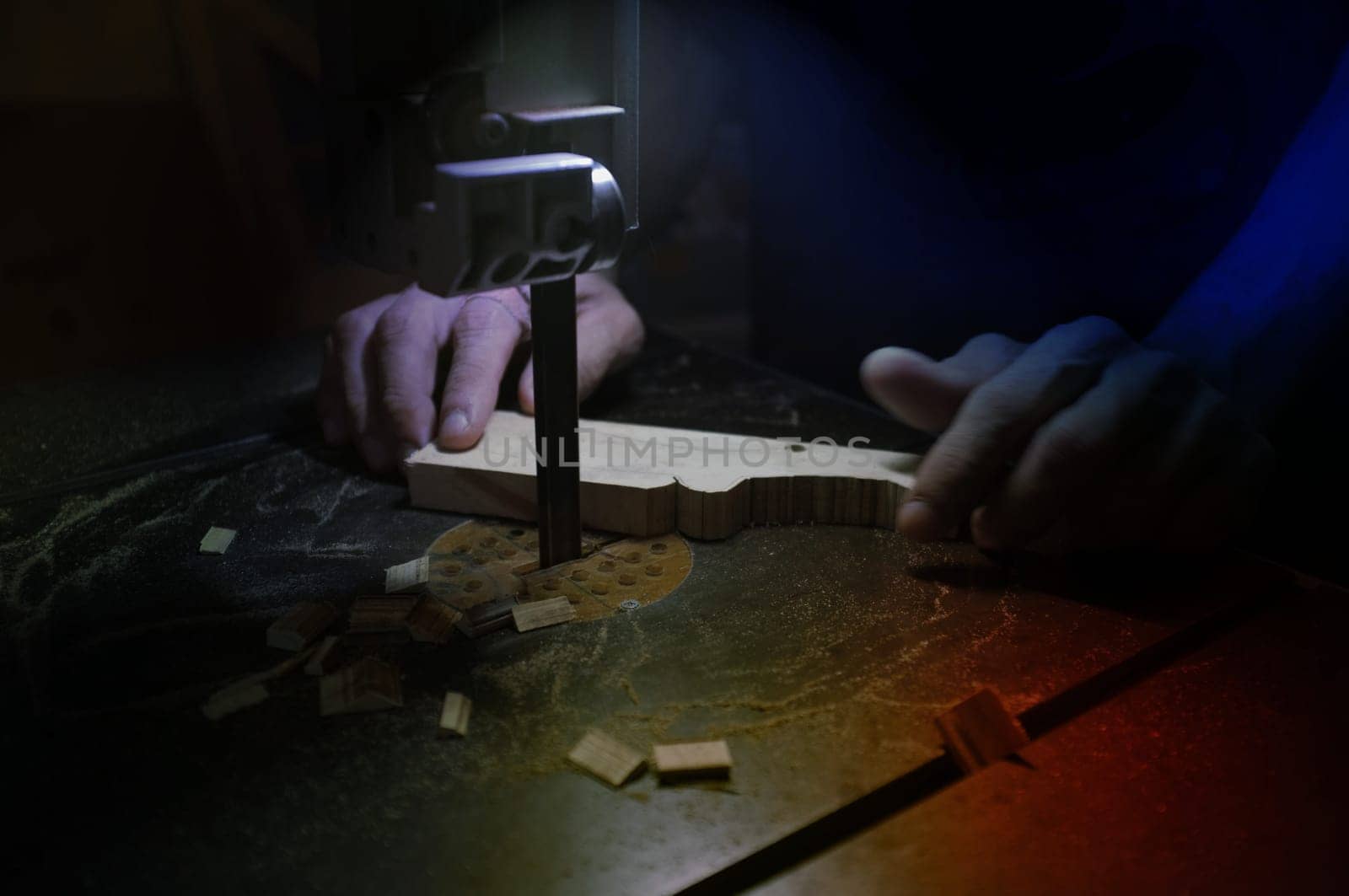 Carpenter builder working with electric jigsaw and wood. Woodworker cutting a piece of wood