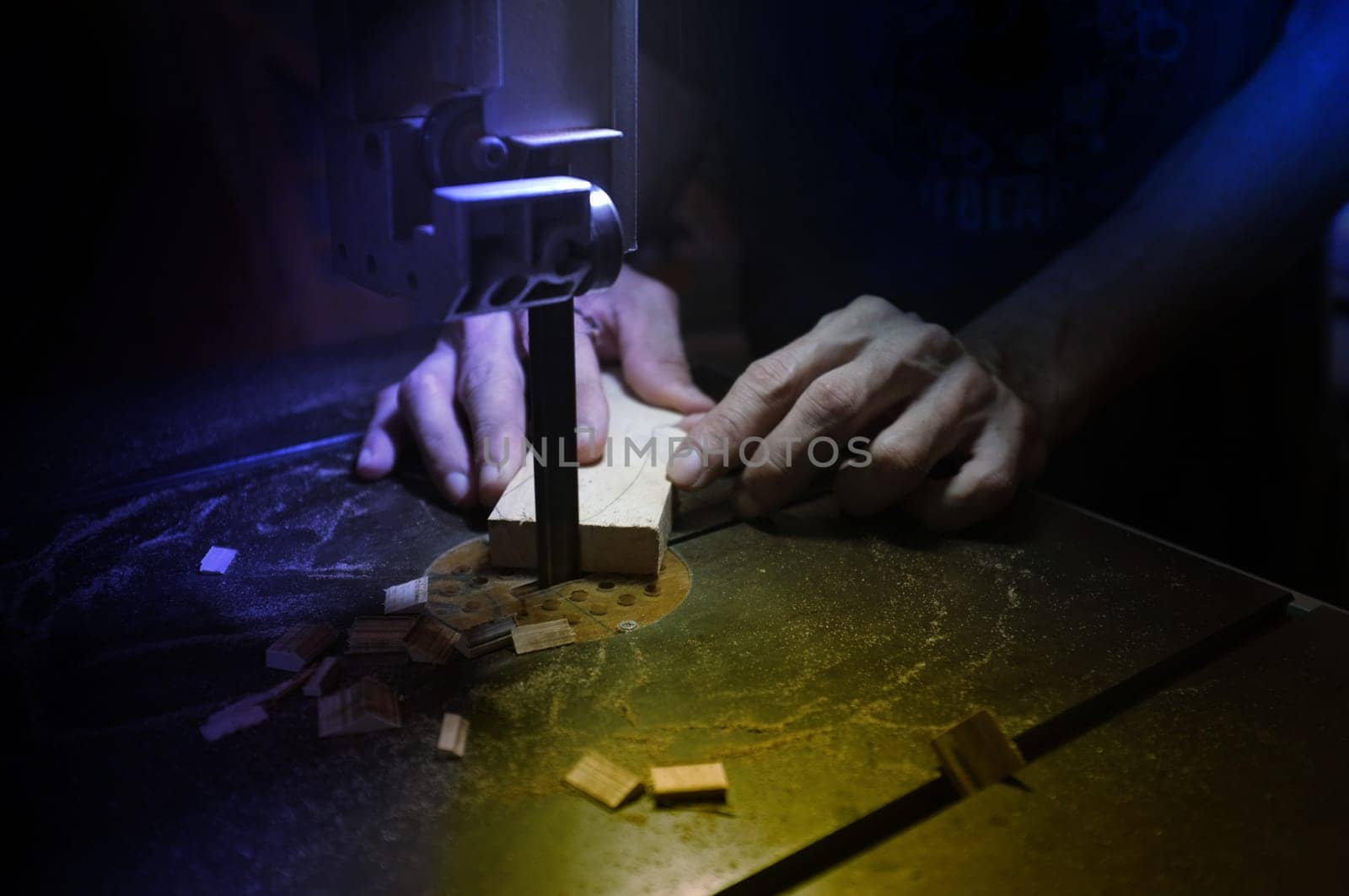 Carpenter builder working with electric jigsaw and wood. Woodworker cutting a piece of wood