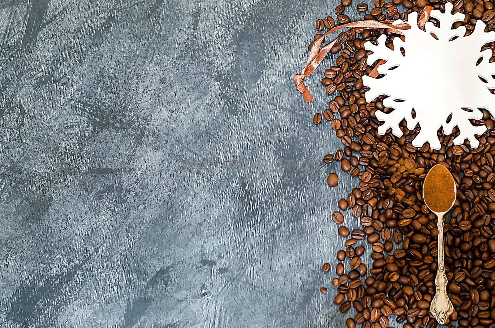 A Christmas background with coffee grains and a large white snowflake with place for text. Top view