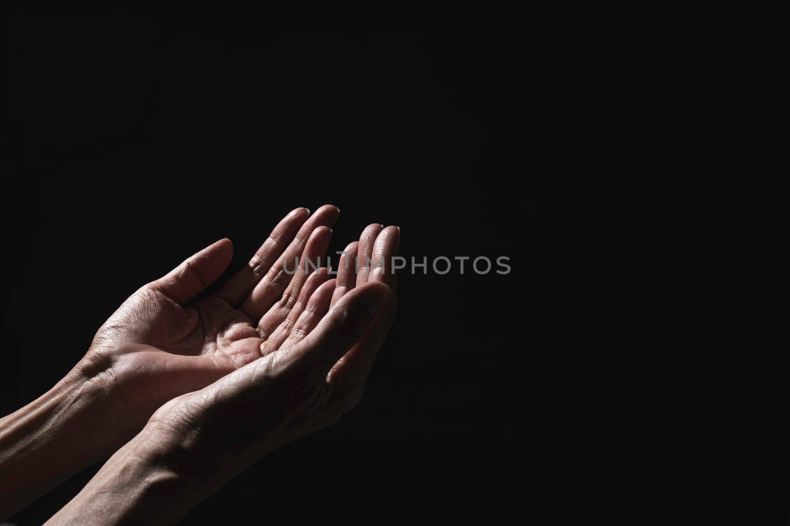 Hand of man while praying for religion. Concept peace and life.