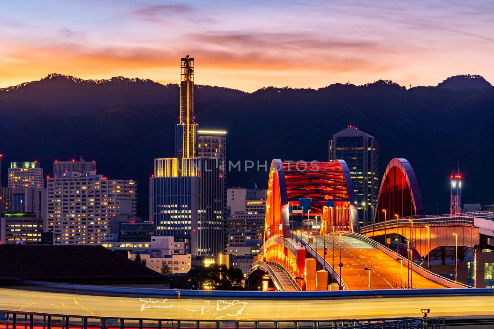 Sunset twilight monorail track and highway red bridge to Kobe downtown Hyogo Kansai Japan