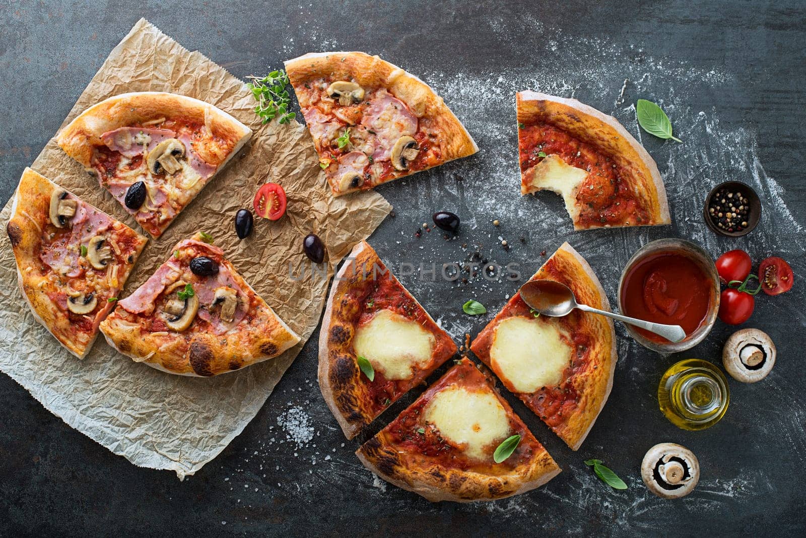 Food ingredients and spices for cooking delicious italian pizza. Pizzas with mushrooms, tomatoes, cheese, ham, oil, pepper, salt, basil, olive on dark concrete background. Copyspace. Top view.