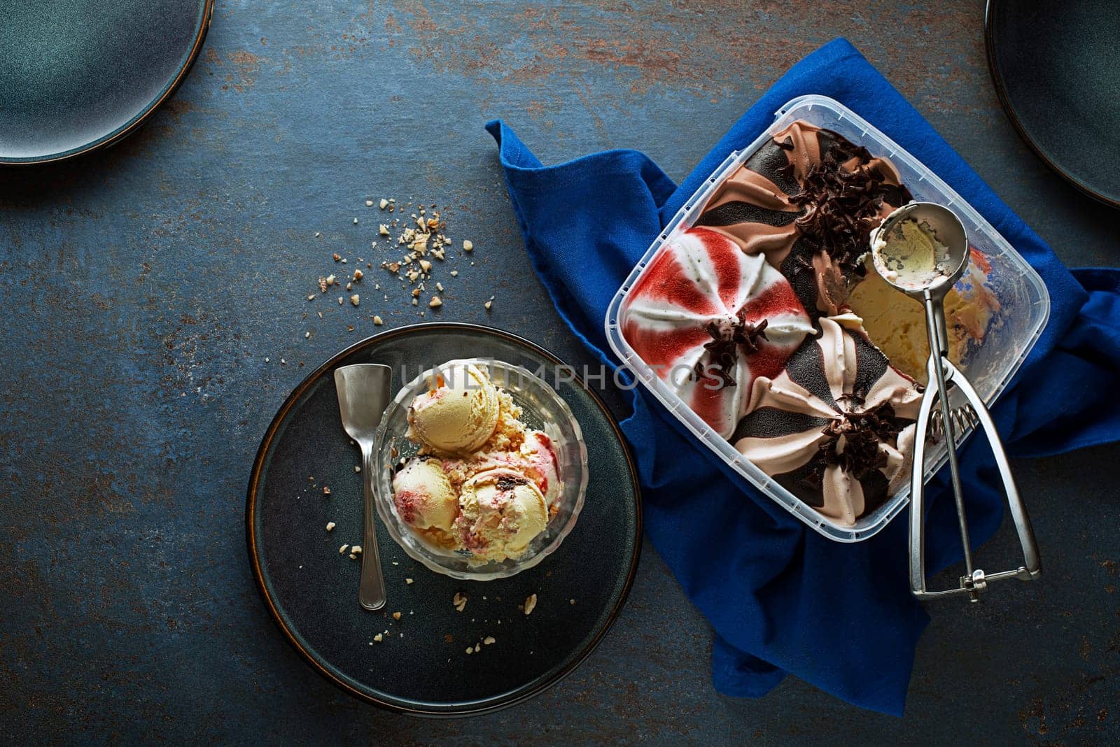 Mixed ice cream scoops, scooped out of a container with a utensil