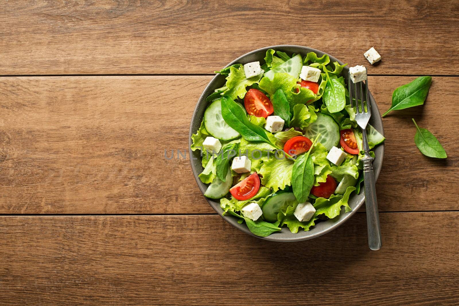 Healthy salad with spinach tomato and cheese. Home made food. Concept for a tasty and healthy meal.