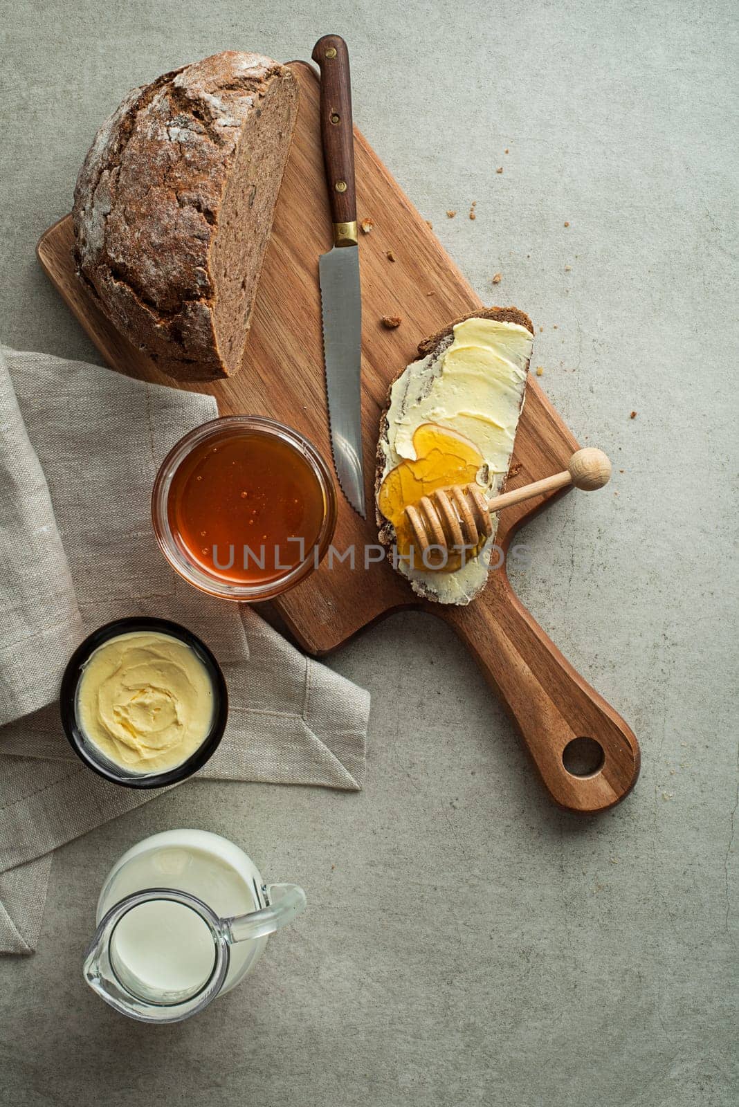 Delicious healthy breakfast with bread, honey, milk and butter