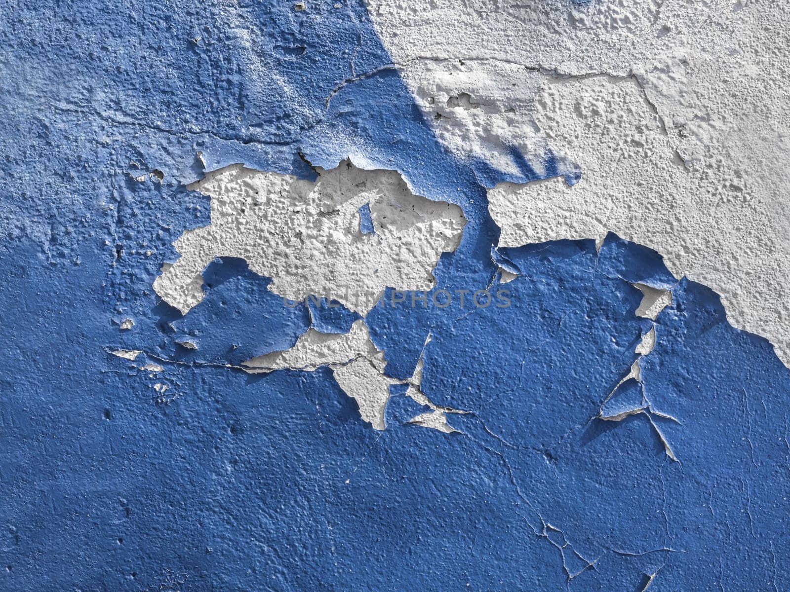 Blue wall with the peeled-off paint. It can be used as background.