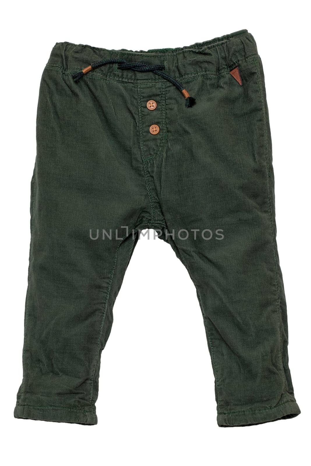 Kids pants isolated. Close-up of a stylish fashionable dark green corduroy trousers with ribbon bow for the little boy. Childrens sporty trousers. Macro.