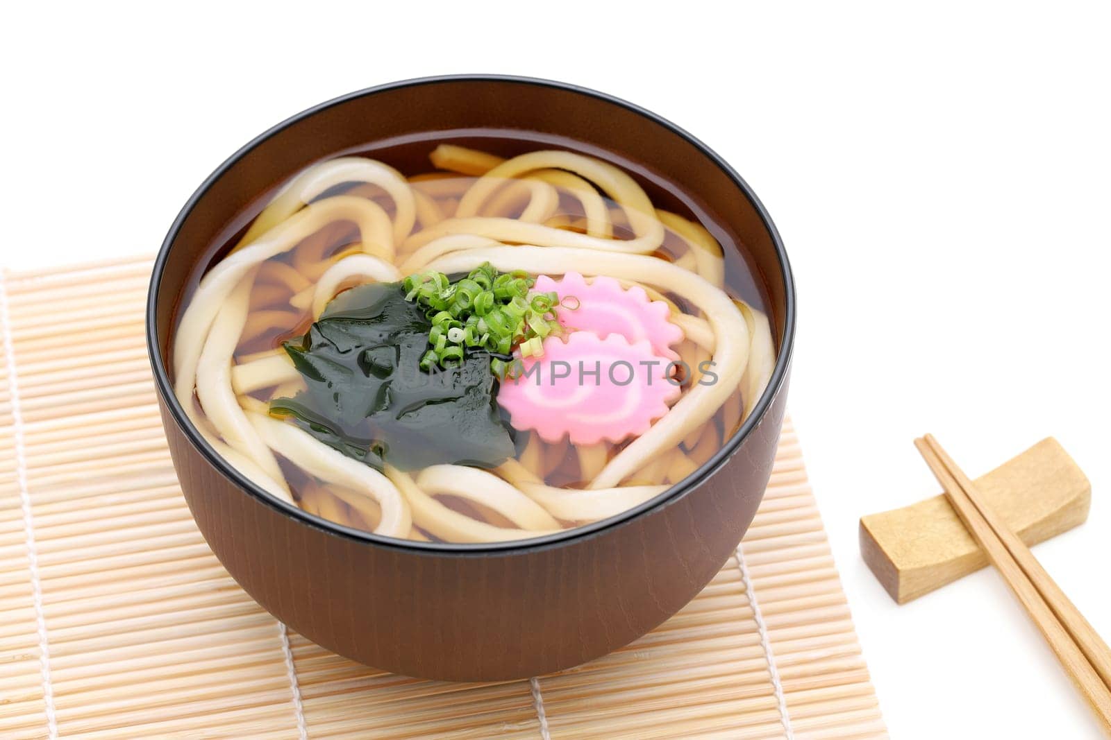Japanese Kake udon noodles in a bowl on white background