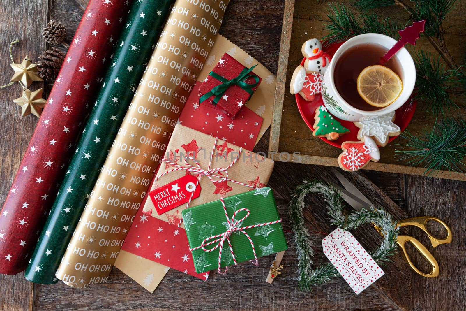 Wrapping little presents with colorful paper for Christmas holidays