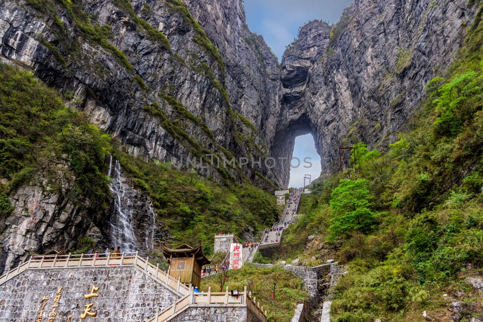 Zhangjiajie, Hunan, China Apr 2013 Tourists climbing 999 stairs to Haven Gate in Tianman Mountains. View from bottom platform on climbing people below
