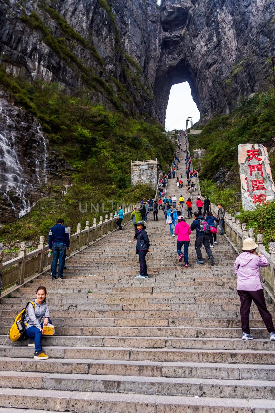 Zhangjiajie, Hunan, China Apr 2013 Tourists climbing 999 stairs to Haven Gate in Tianman Mountains. View from bottom platform on climbing people below