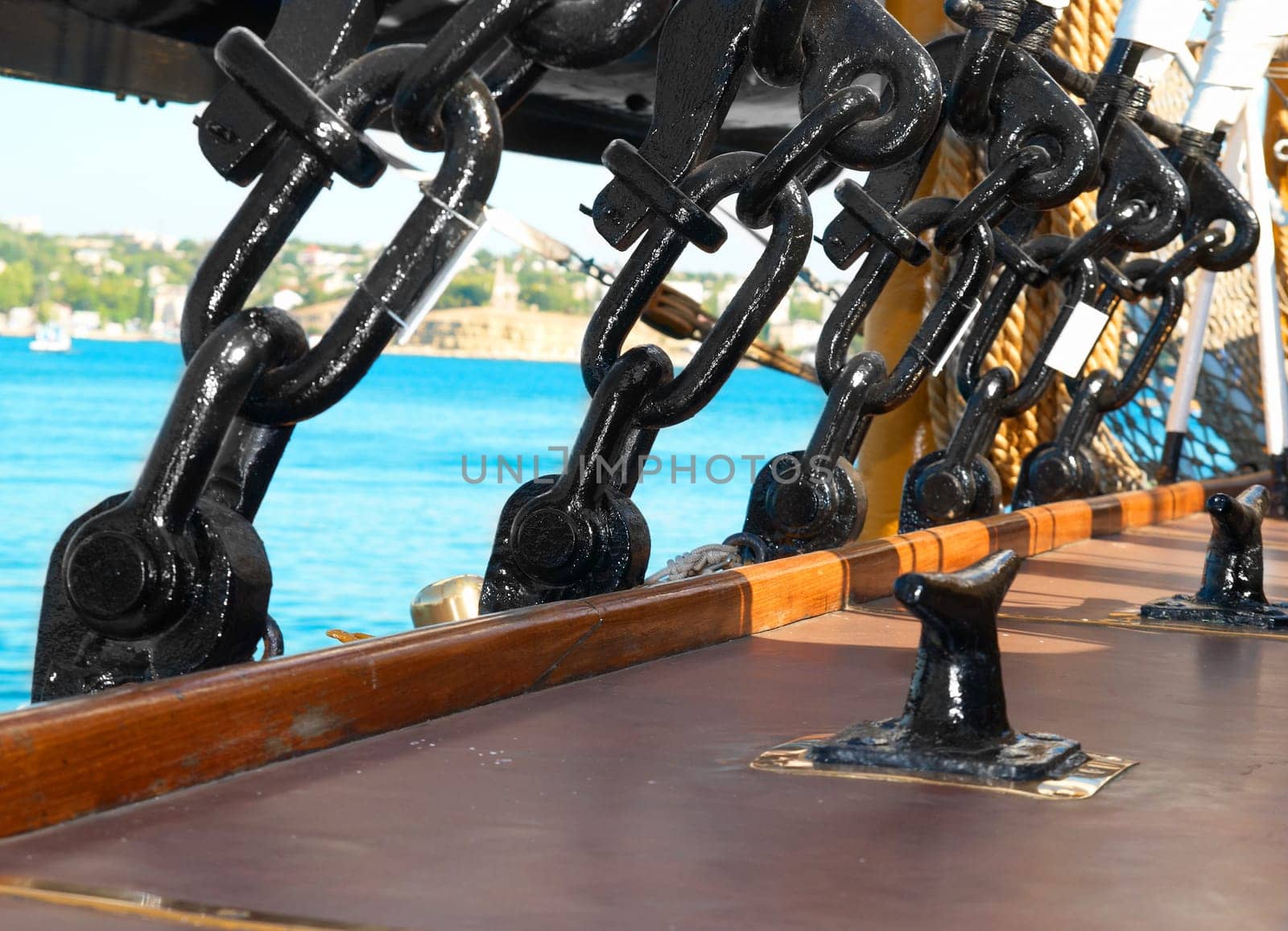 Black metal rigging and ropes on a deck of sail ship