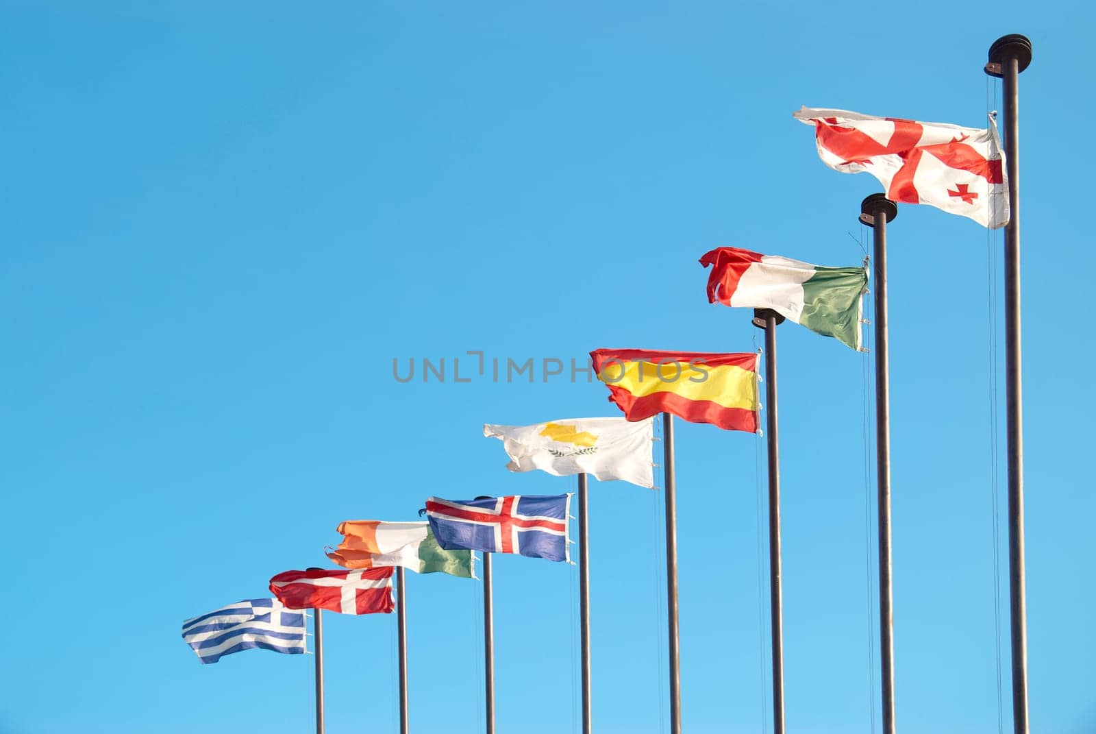 Row of european flags against blue sky background