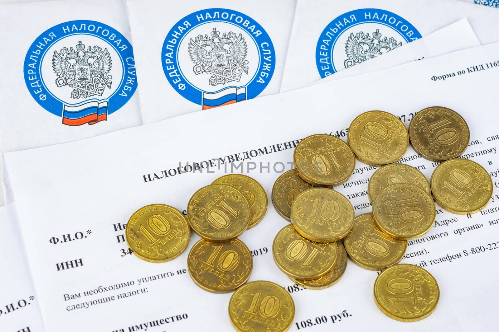 Anapa, Russia - September 3, 2019: Tax notice, tax envelopes and ten ruble coins