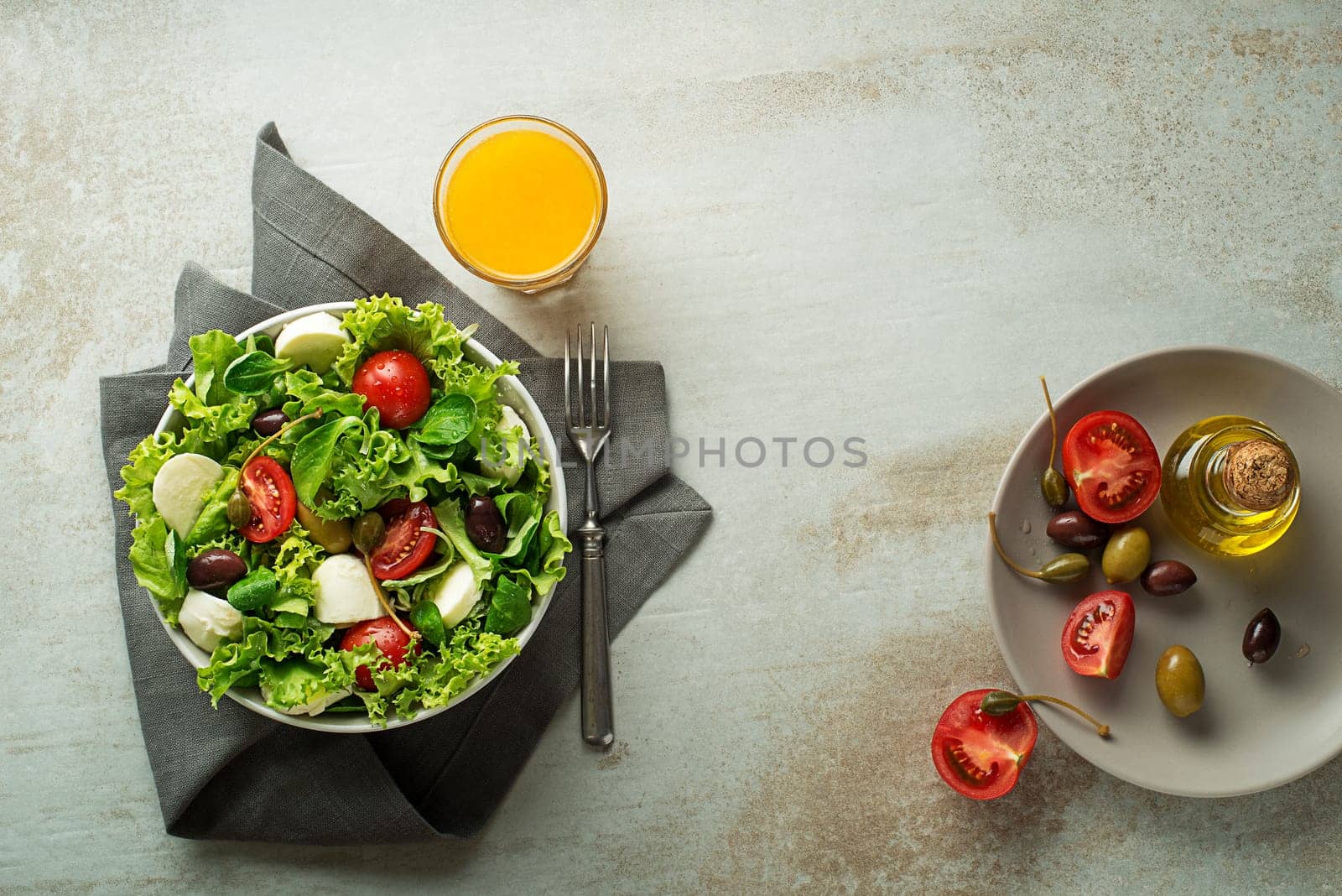 Healthy green salad with tomato and mozzarella cheese. Home made food. Concept for a tasty and healthy meal