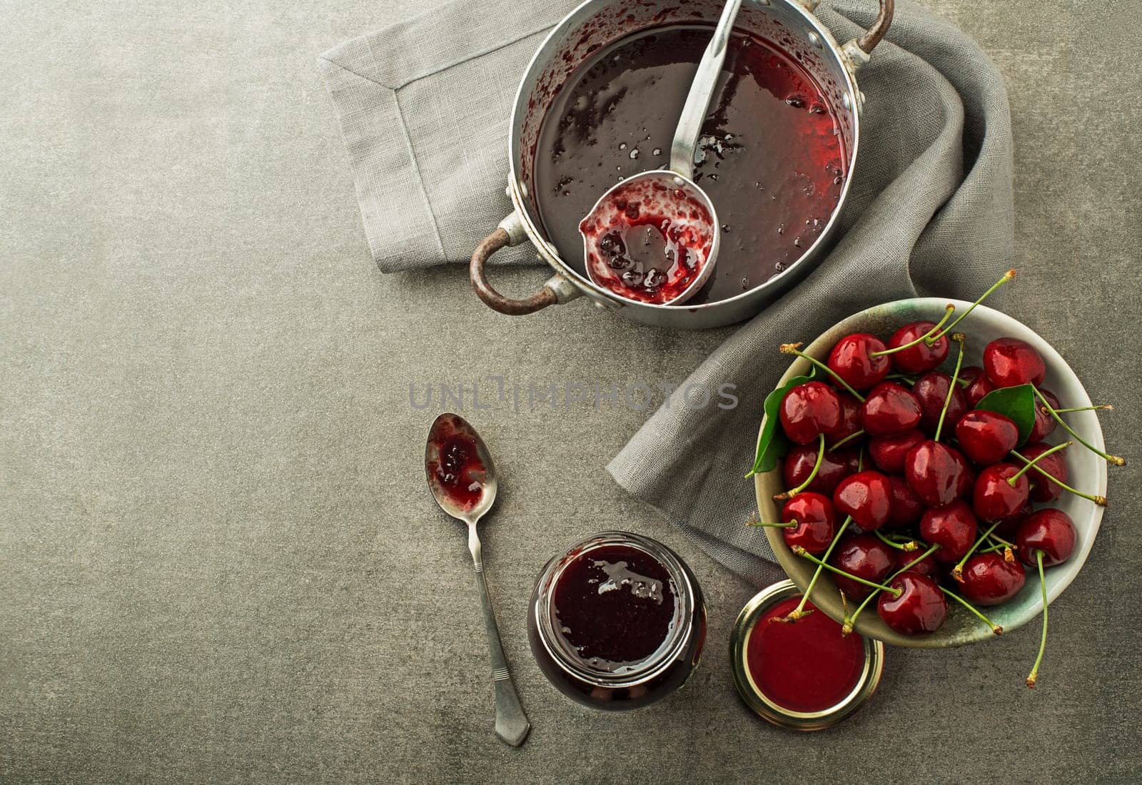 Homemade marmalade or jam from fresh red cherries on the table close up