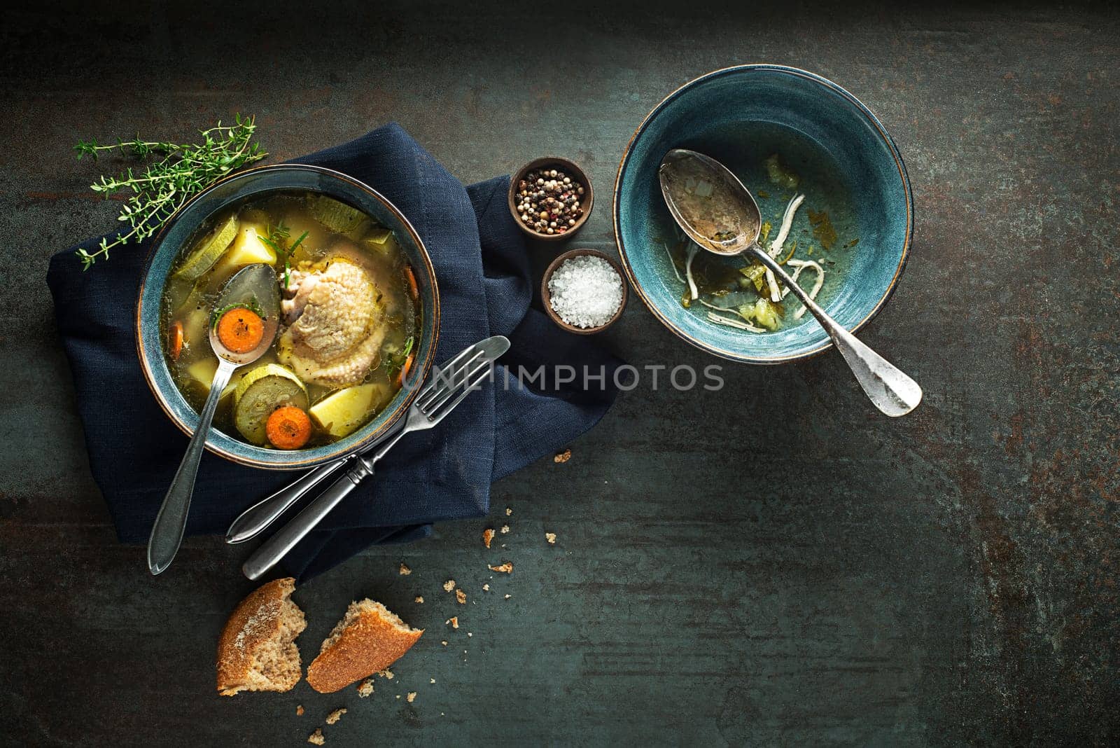 Eating Healthy Chicken soup with vegetables and herbs on dark background