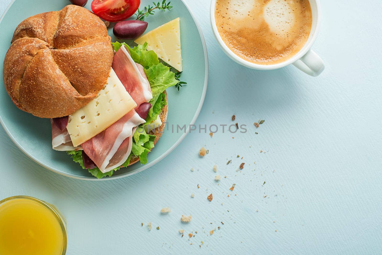Breakfast served with coffee, juice, sandwich with ham, cheese, tomato and lettuce. Continental delicious healthy breakfast table