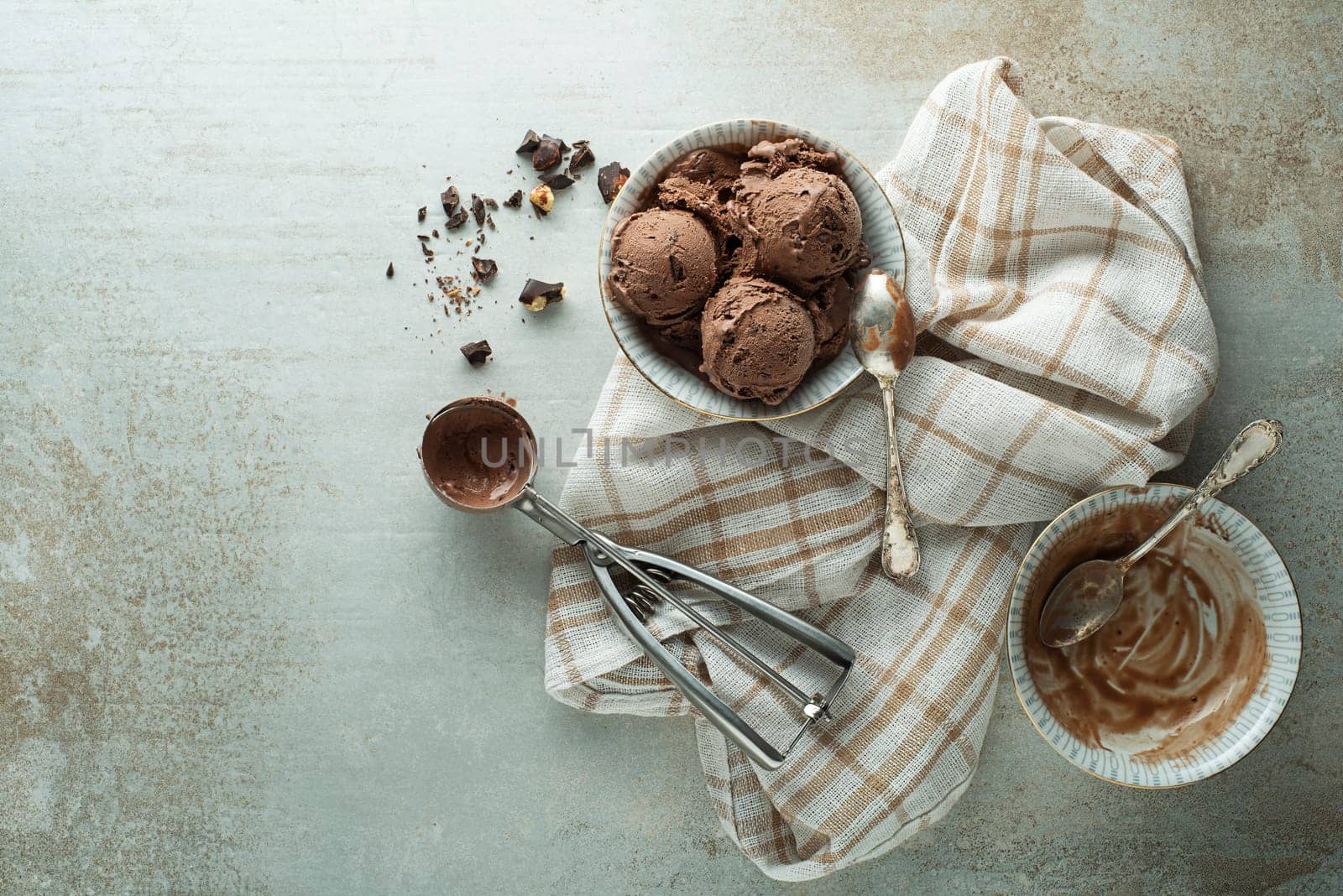 Chocolate ice cream scoop, scooped out of a container with a utensil
