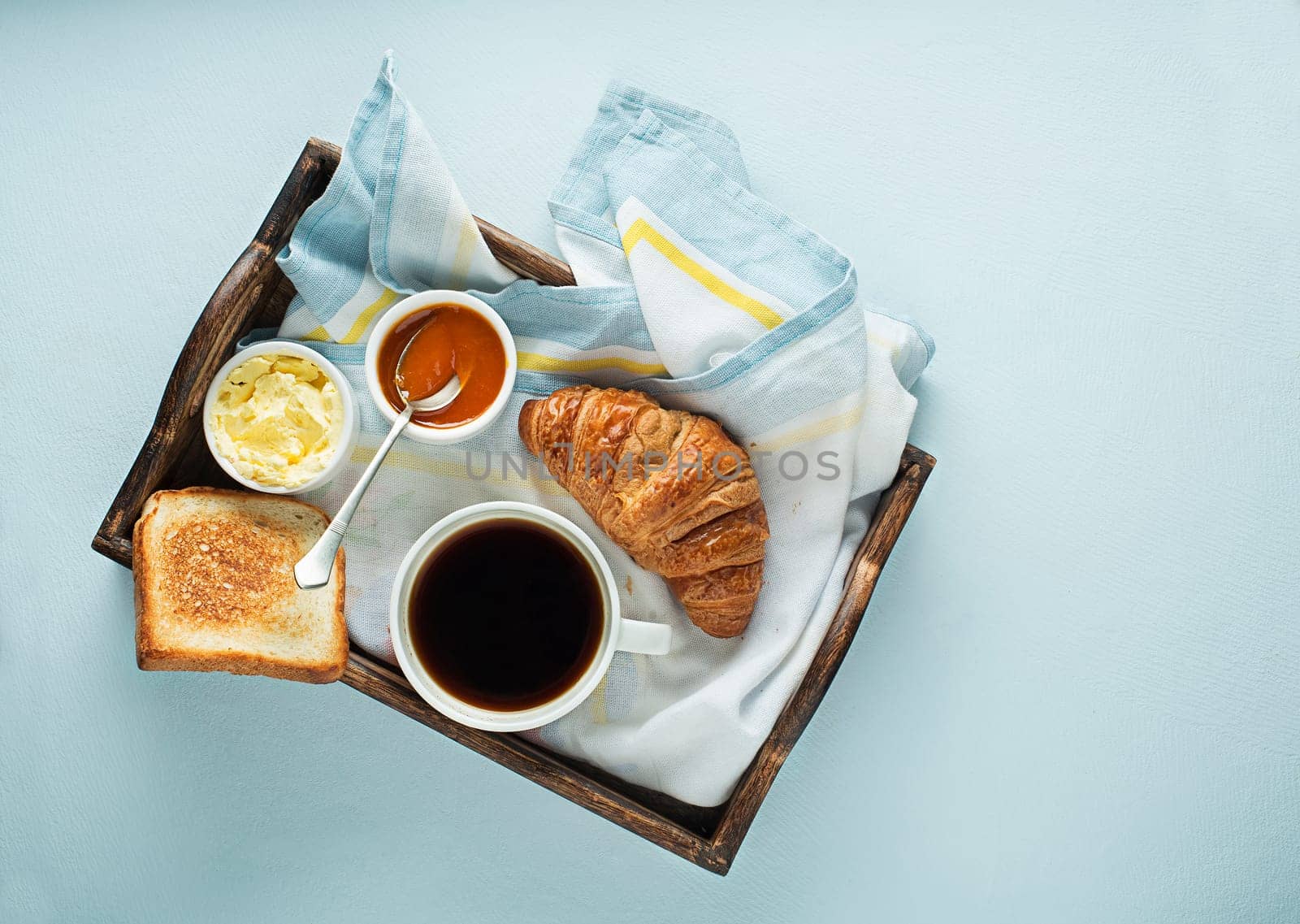 Breakfast served with coffee, croissant, bread, jam and butter. Continental delicious healthy breakfast