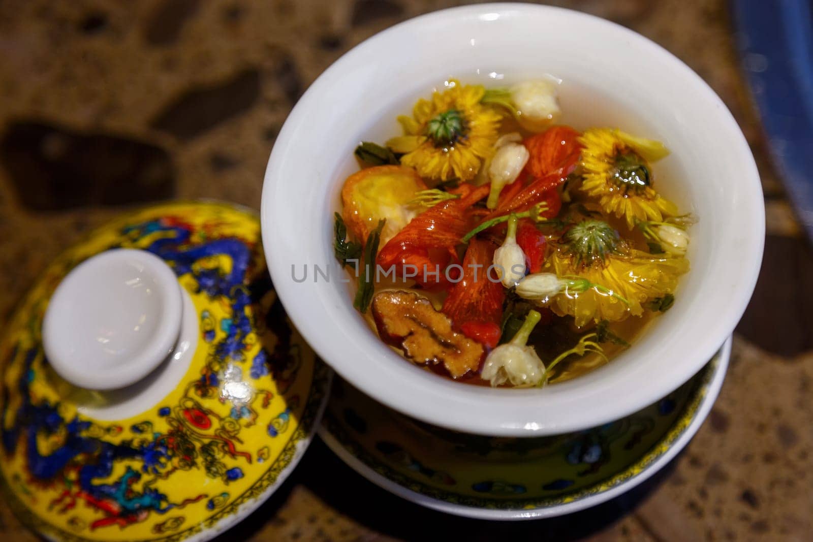 Flower tea in a closing Chinese cup on a table in a cafe