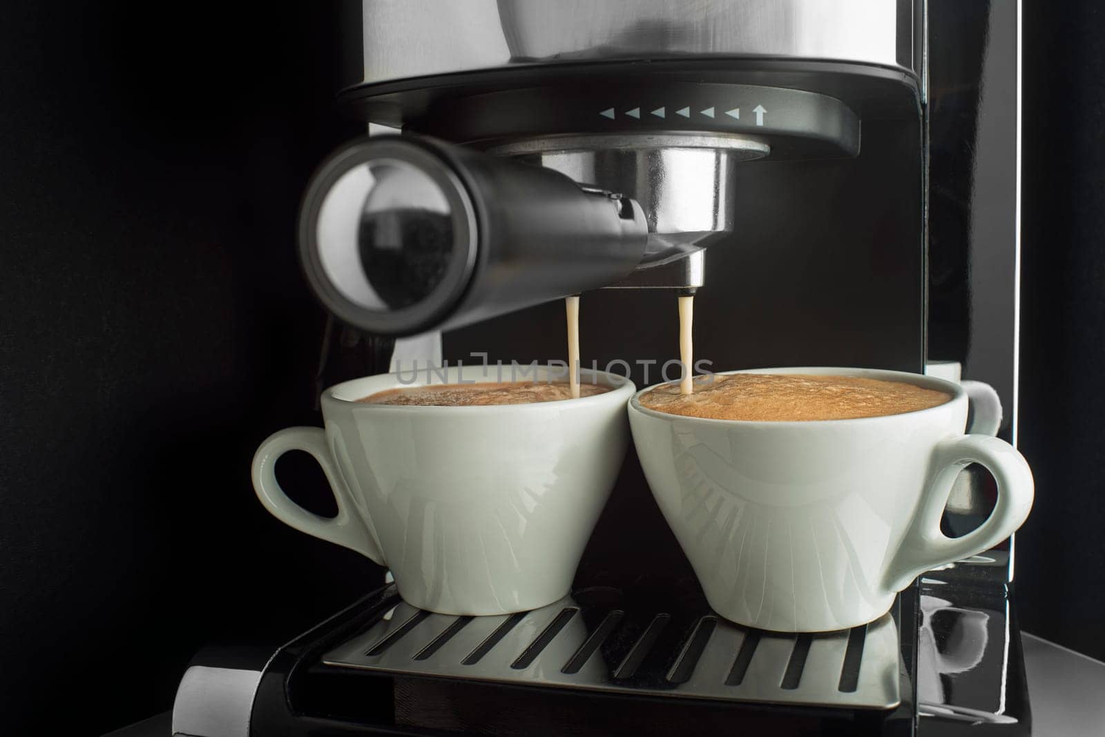 Espresso coffee pouring from coffee machine. Professional coffee brewing