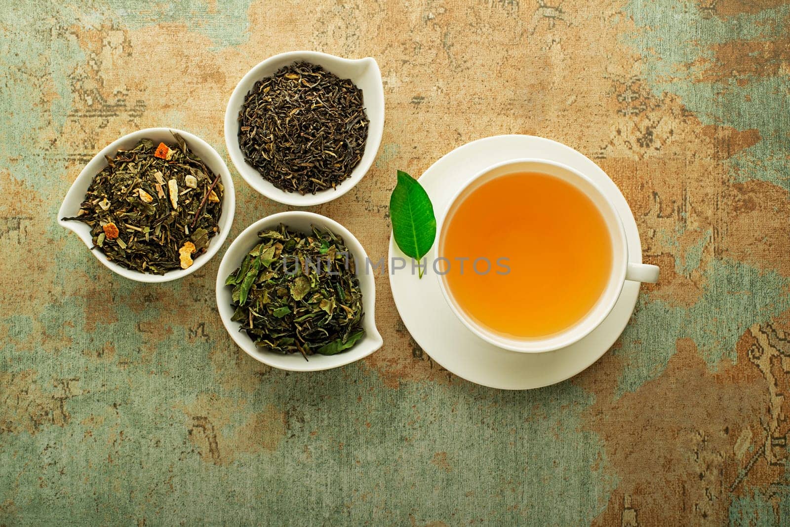 Cup of tea with dry tea collection of different types- classic black and green tea flavour