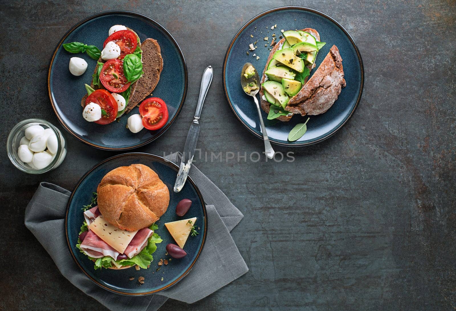 Breakfast served with different sandwiches with vegetable cheese and ham. Continental delicious healthy breakfast table