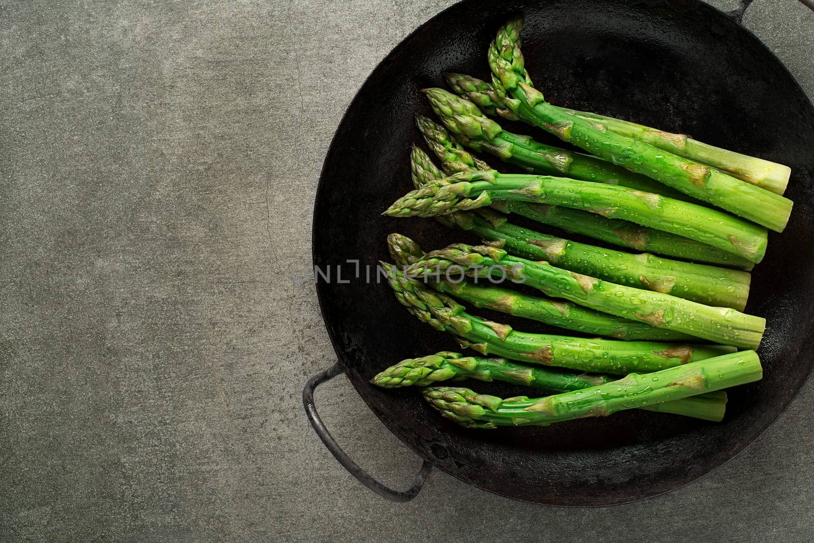 Fresh of green Asparagus. Cooking healthy meal in pan. Bunches of green asparagus