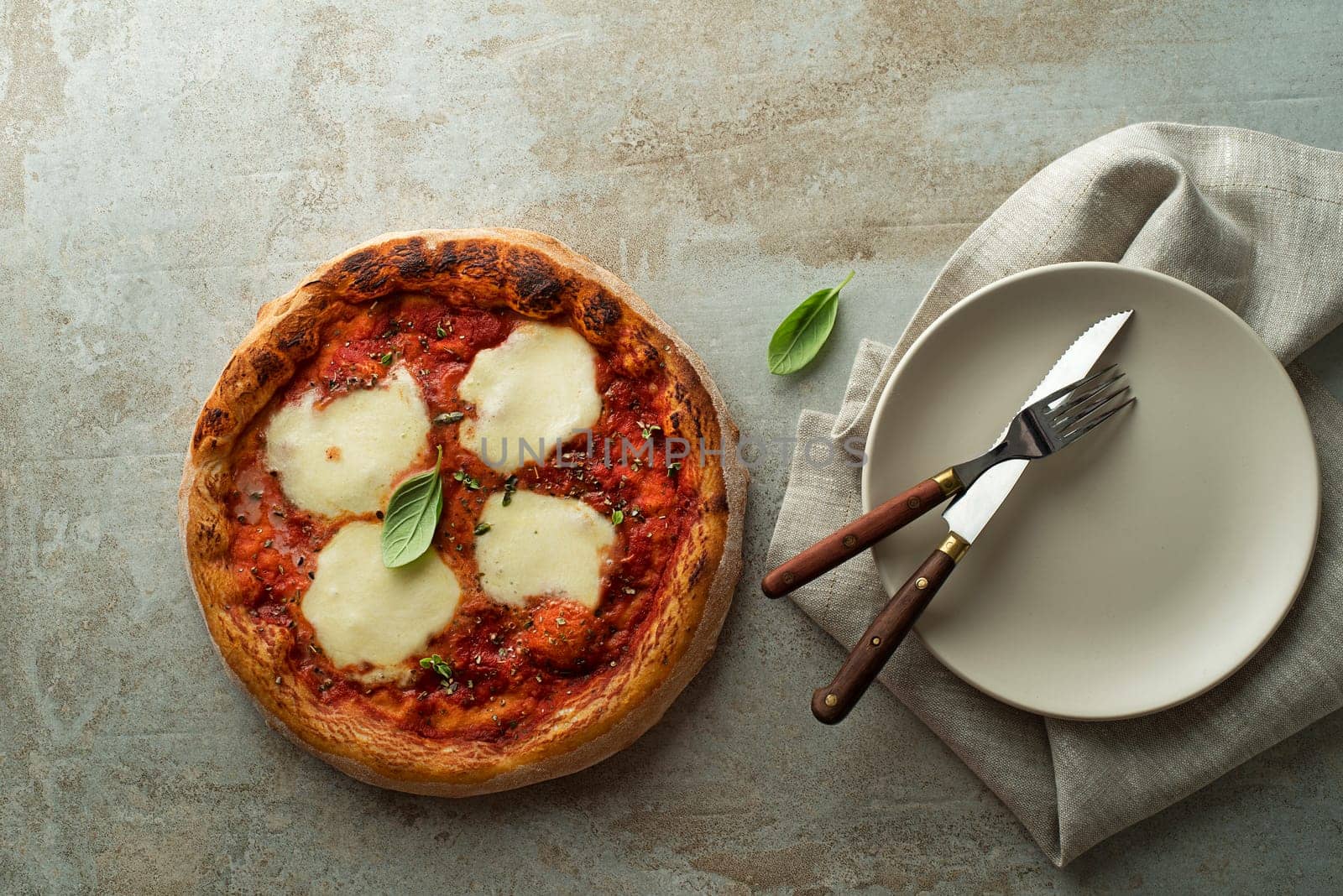 Pizza Margherita served with mozzarella cheese, tomato sauce and fresh basil