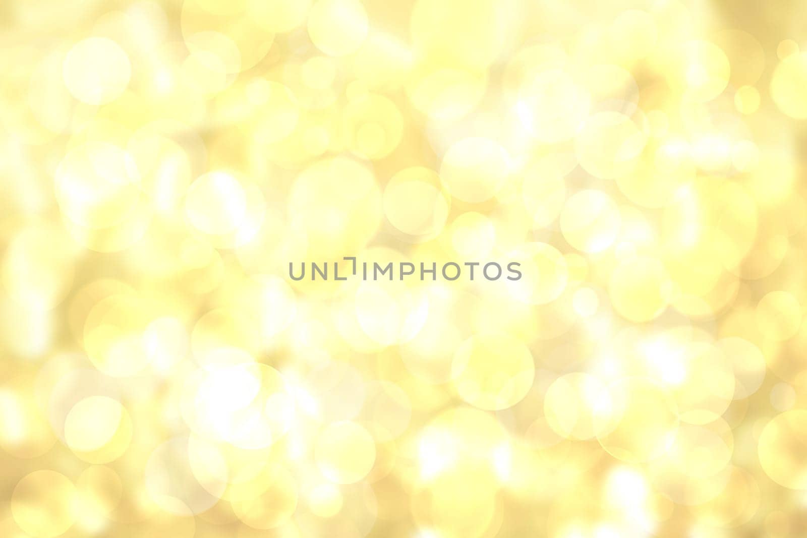 A festive abstract delicate golden yellow gradient background texture with glitter defocused sparkle bokeh circles. Card concept for Happy New Year, party invitation, valentine or other holidays.